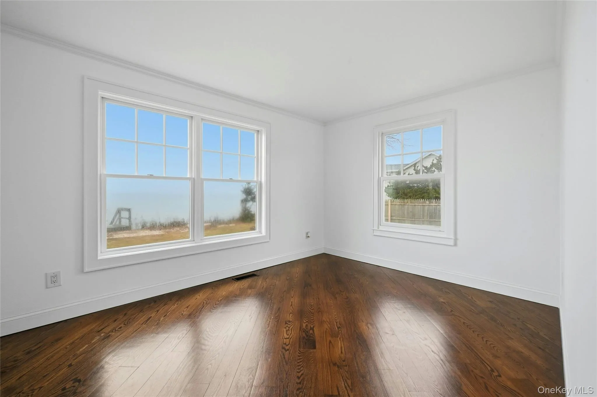 Empty room with ornamental molding and dark wood-type flooring Empty room with ornamental molding and dark wood-type flooring