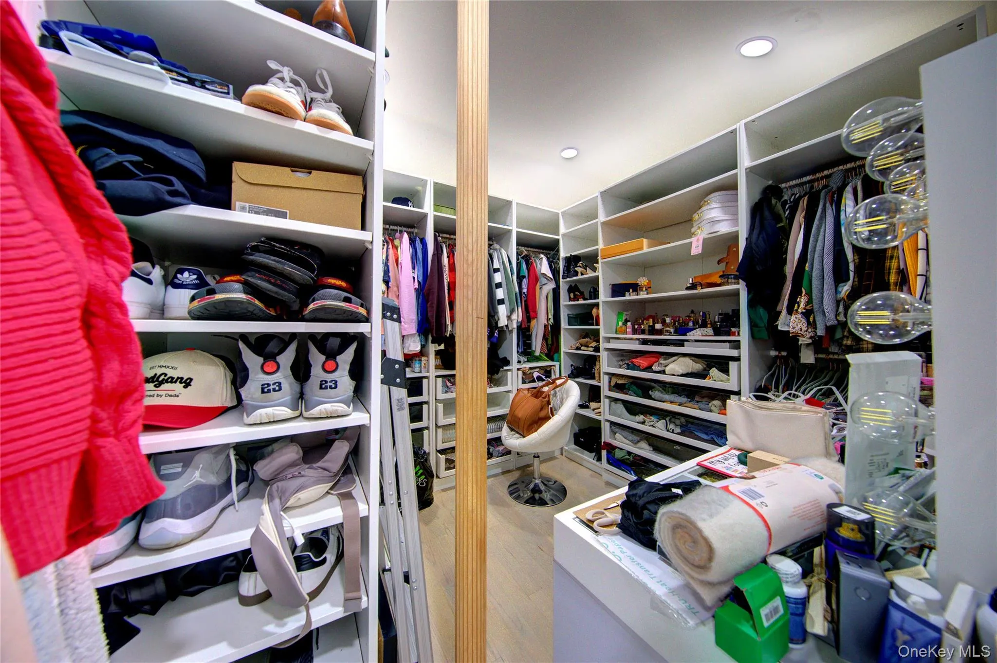 Walk in closet featuring light wood finished floors Walk in closet featuring light wood finished floors