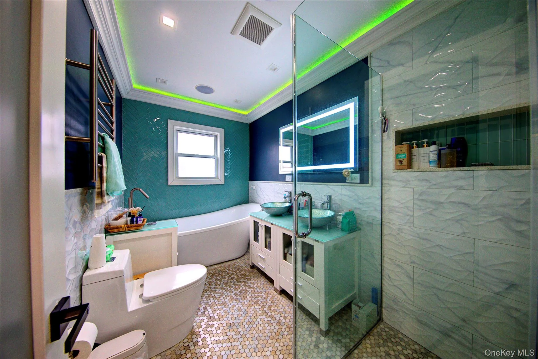 Full bath featuring ornamental molding, tile walls, vanity, a bath, and tile patterned floors Full bath featuring ornamental molding, tile walls, vanity, a bath, and tile patterned floors