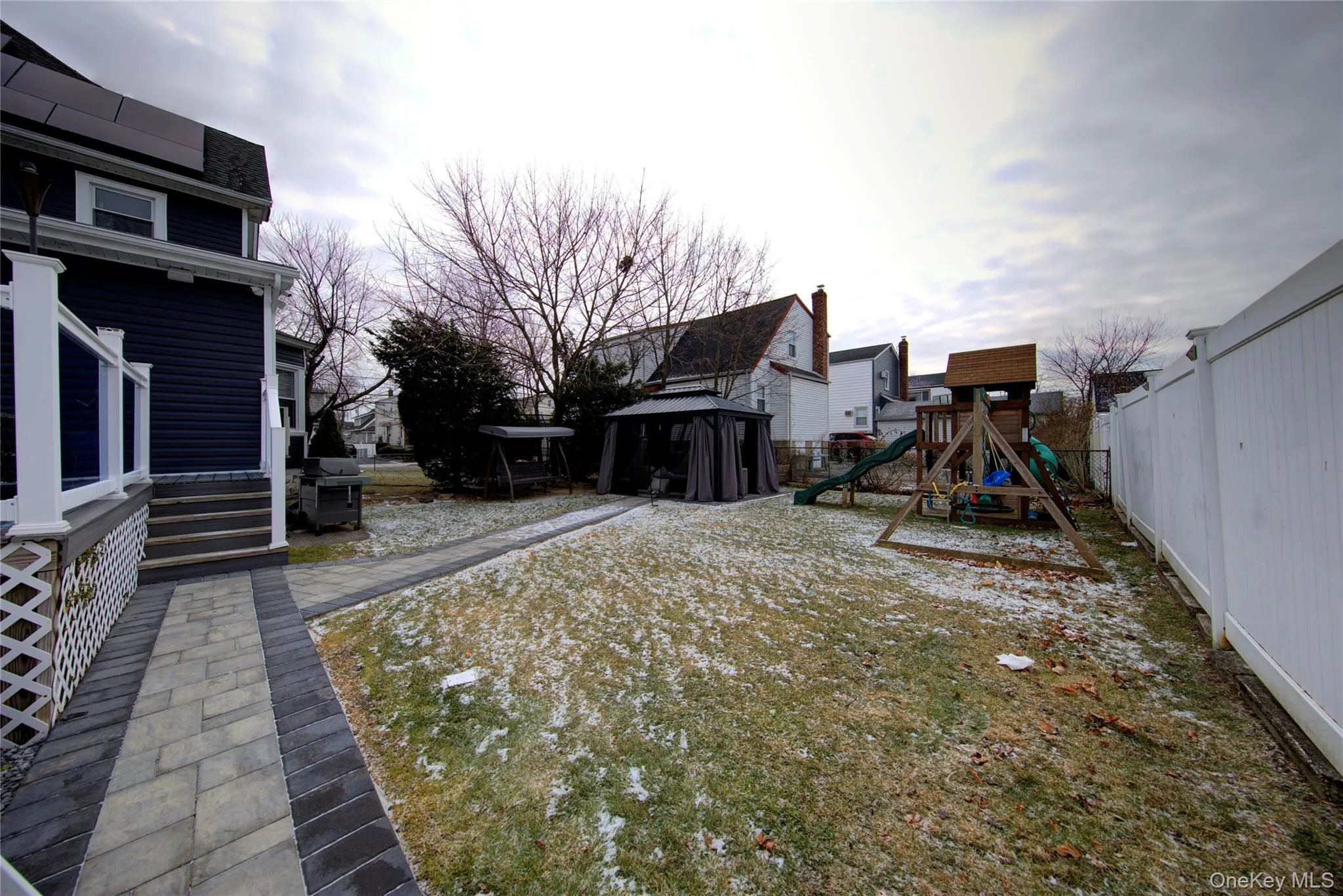 Fenced backyard featuring a playground Fenced backyard featuring a playground