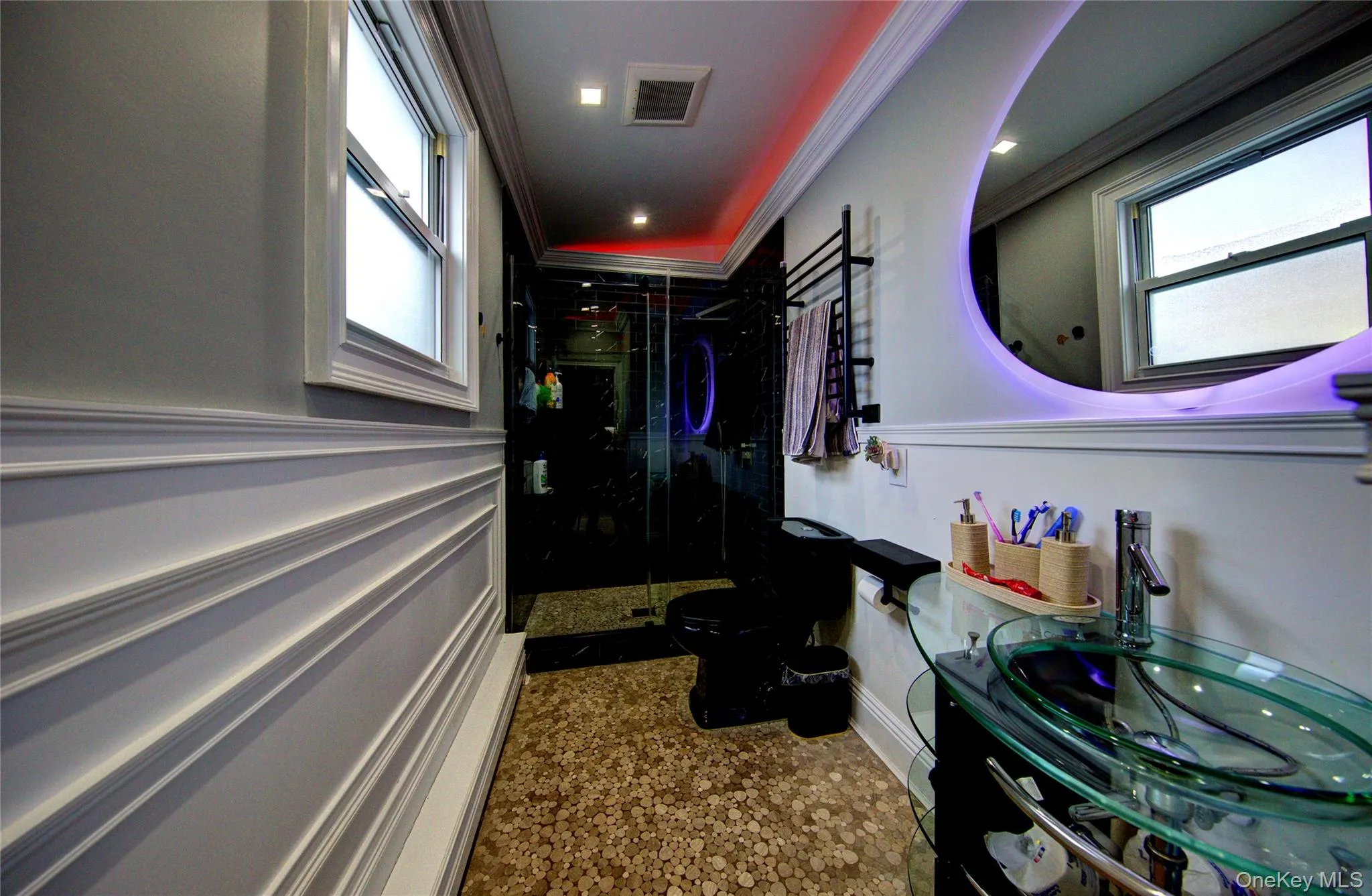 Bathroom featuring a towel warmer, a shower stall, and crown molding Bathroom featuring a towel warmer, a shower stall, and crown molding