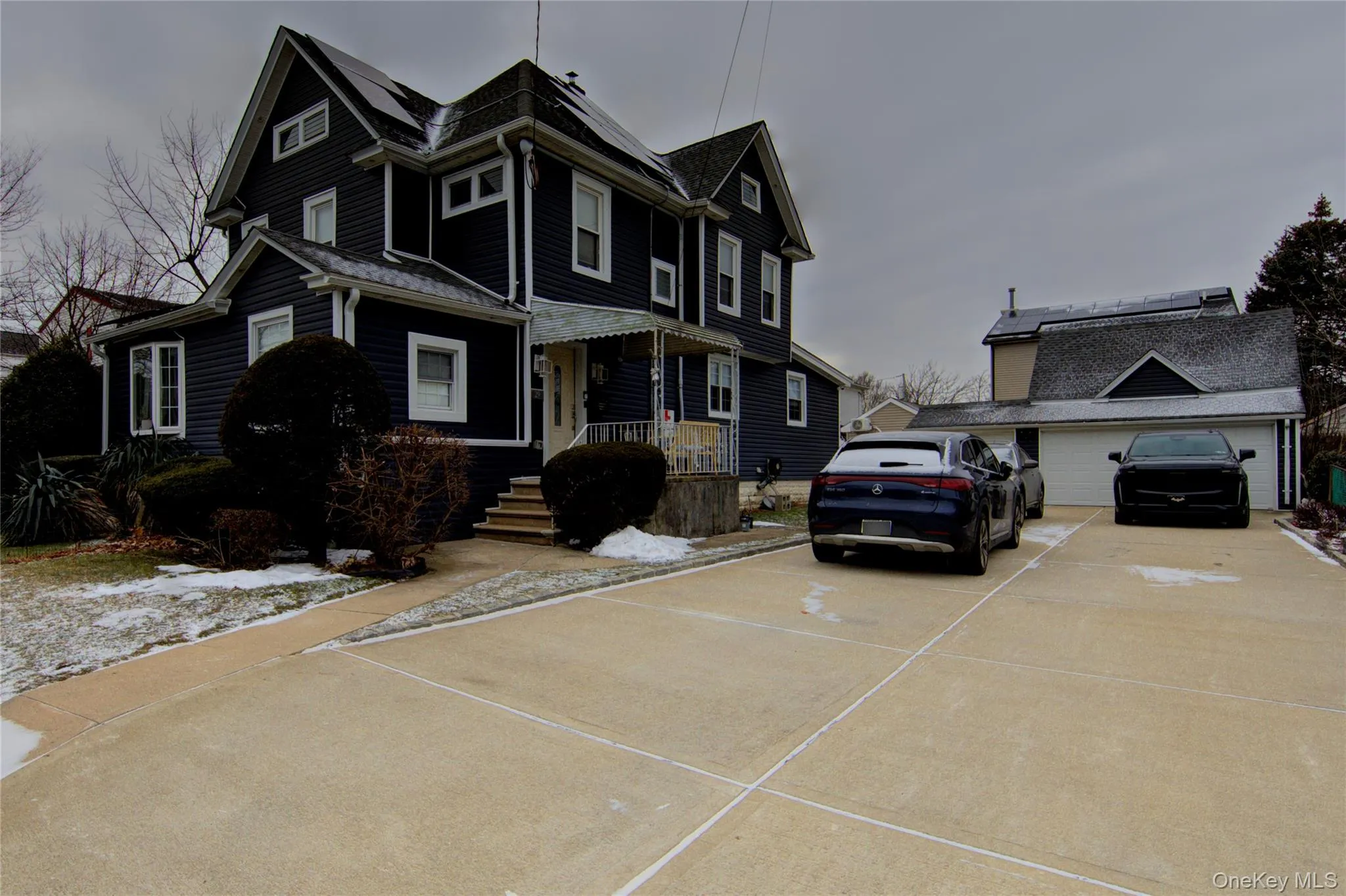 View of front of property with an outbuilding, driveway, and covered porch View of front of property with an outbuilding, driveway, and covered porch