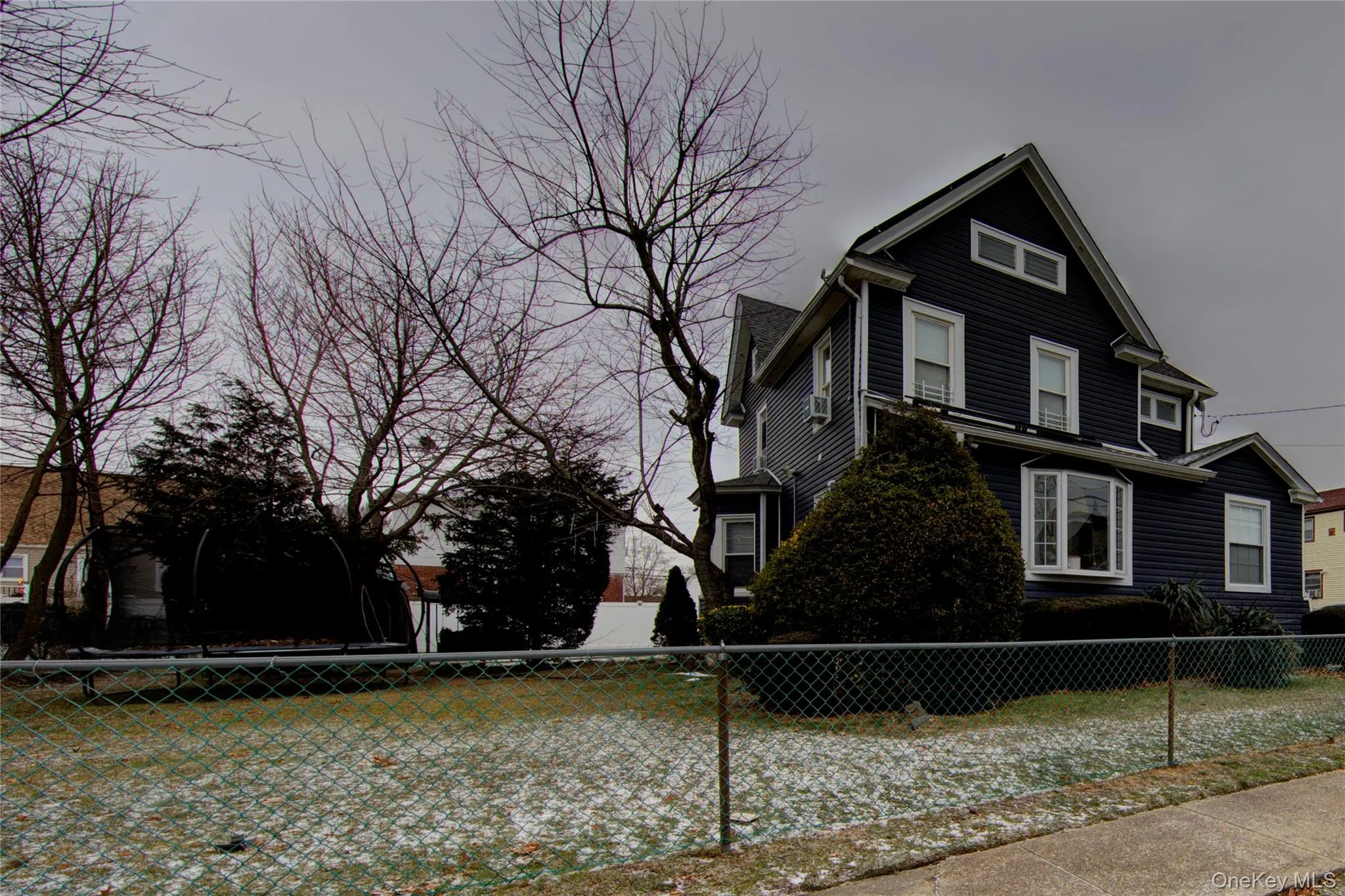 View of property exterior with a fenced front yard View of property exterior with a fenced front yard