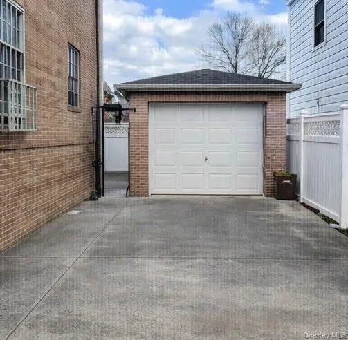 Detached garage featuring concrete driveway Detached garage featuring concrete driveway