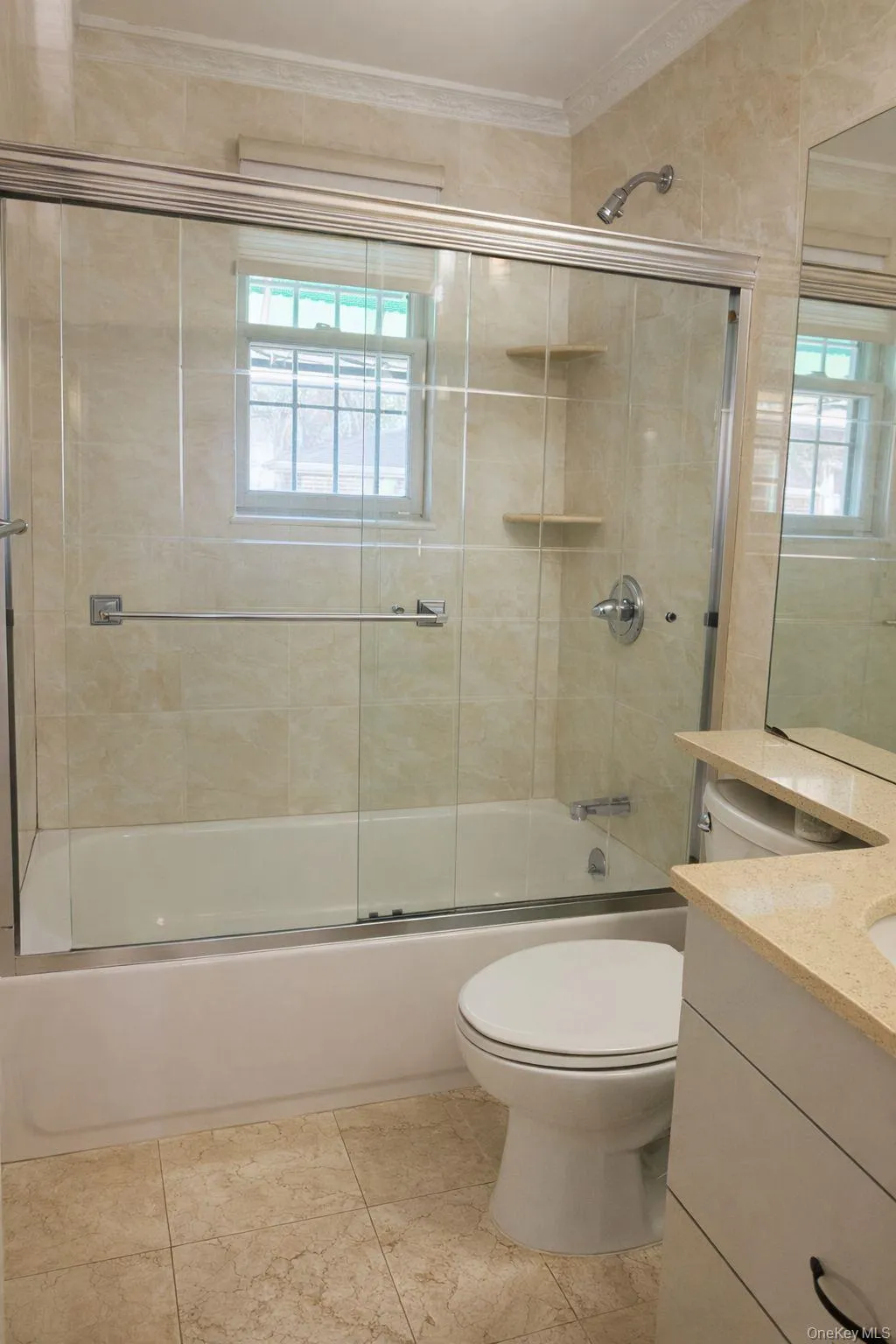 Full bath with vanity, bath / shower combo with glass door, and crown molding Full bath with vanity, bath / shower combo with glass door, and crown molding