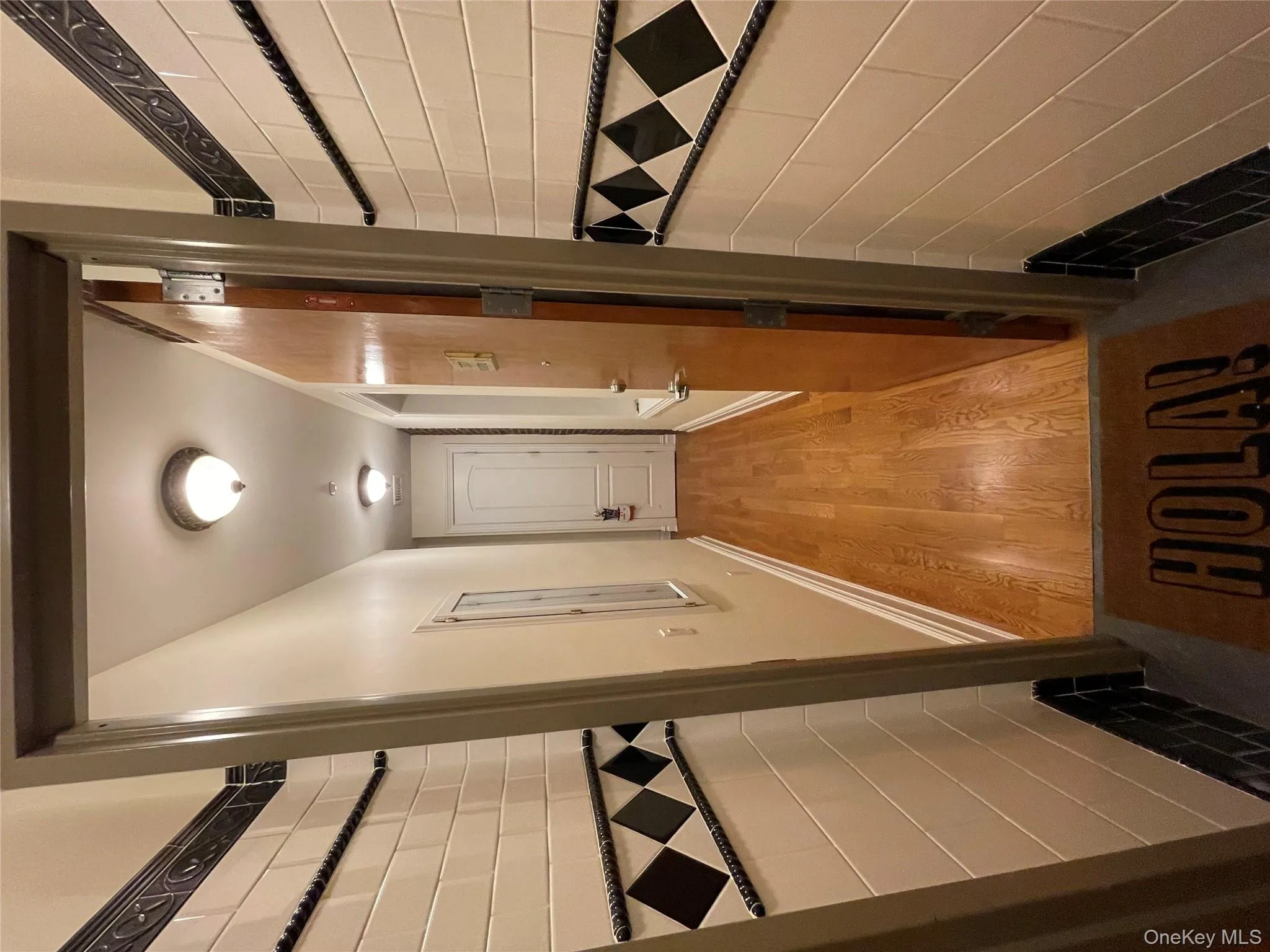 Hall featuring light wood-style flooring and baseboards Hall featuring light wood-style flooring and baseboards