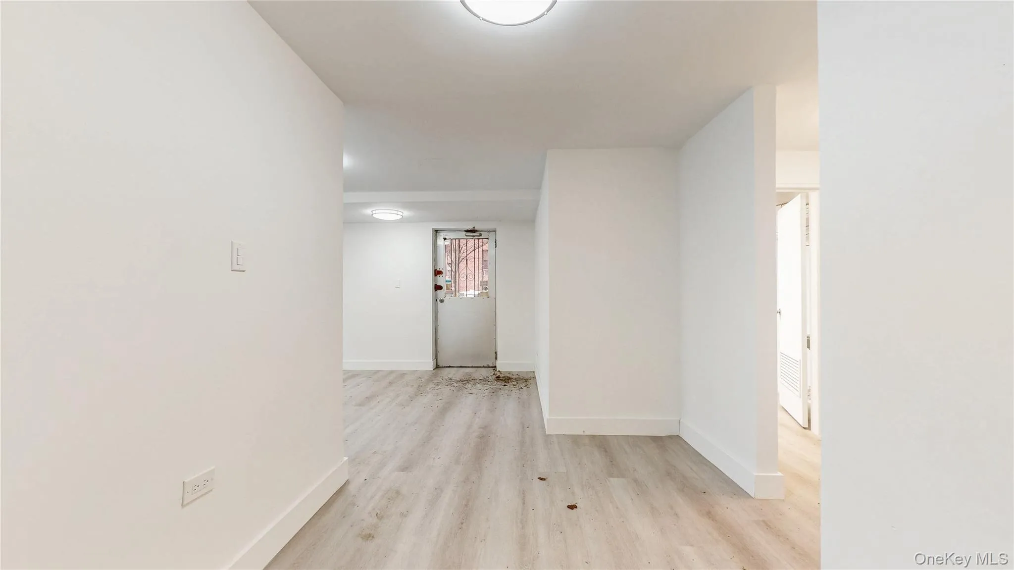 Corridor with light wood-style flooring and baseboards Corridor with light wood-style flooring and baseboards