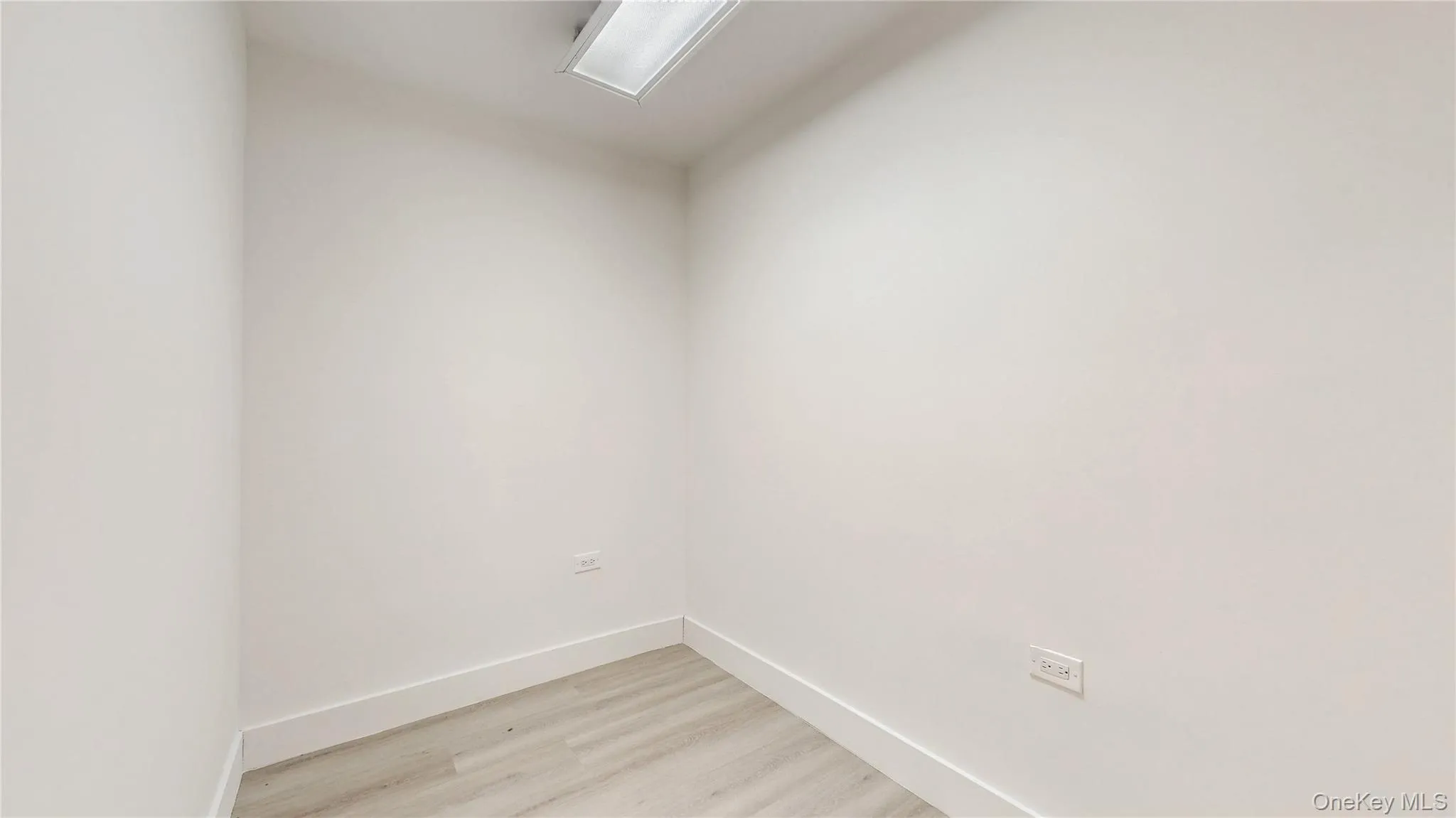 Unfurnished room featuring light wood-style flooring and baseboards Unfurnished room featuring light wood-style flooring and baseboards