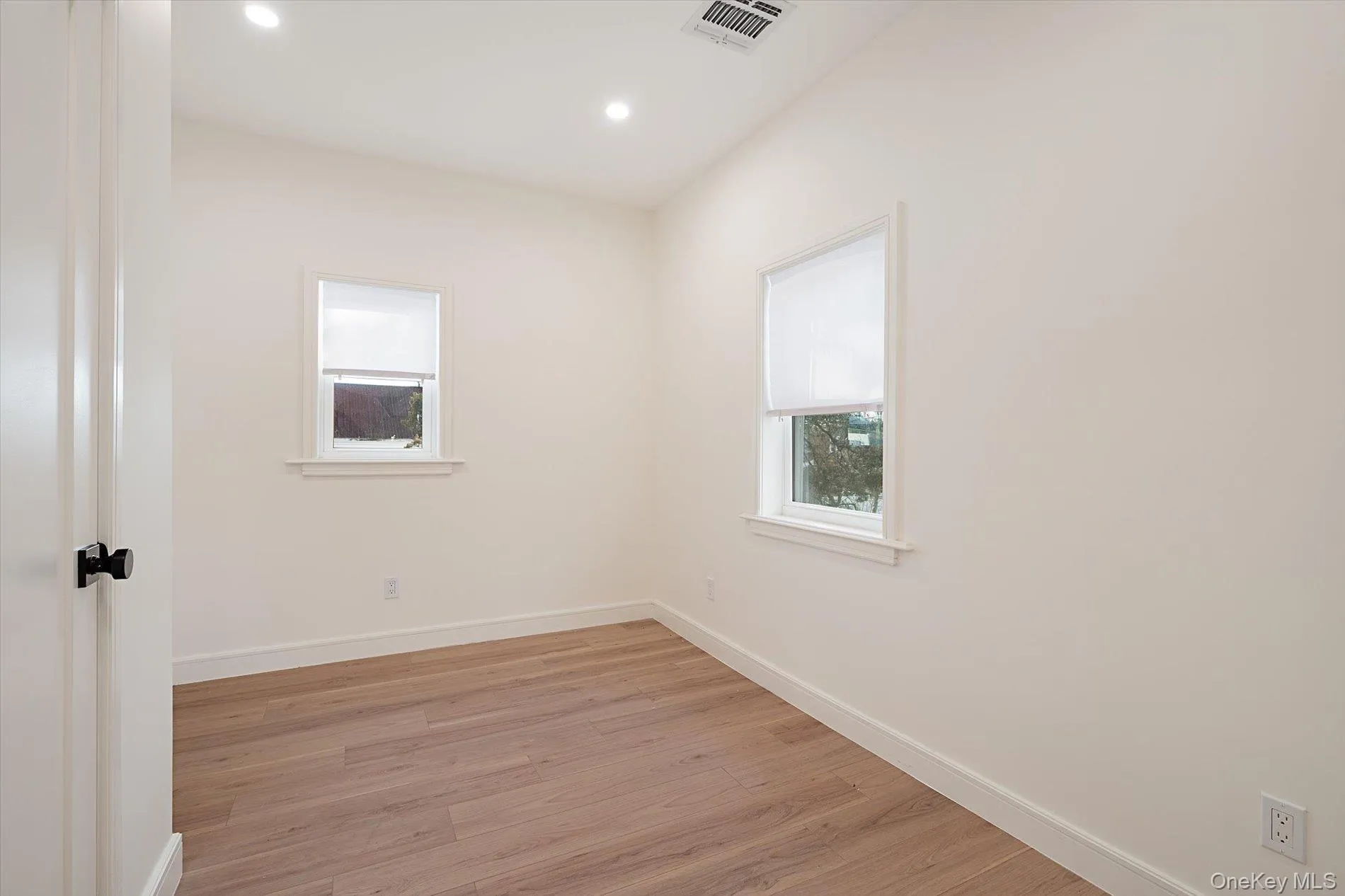 Unfurnished room featuring light wood-style flooring and recessed lighting Unfurnished room featuring light wood-style flooring and recessed lighting