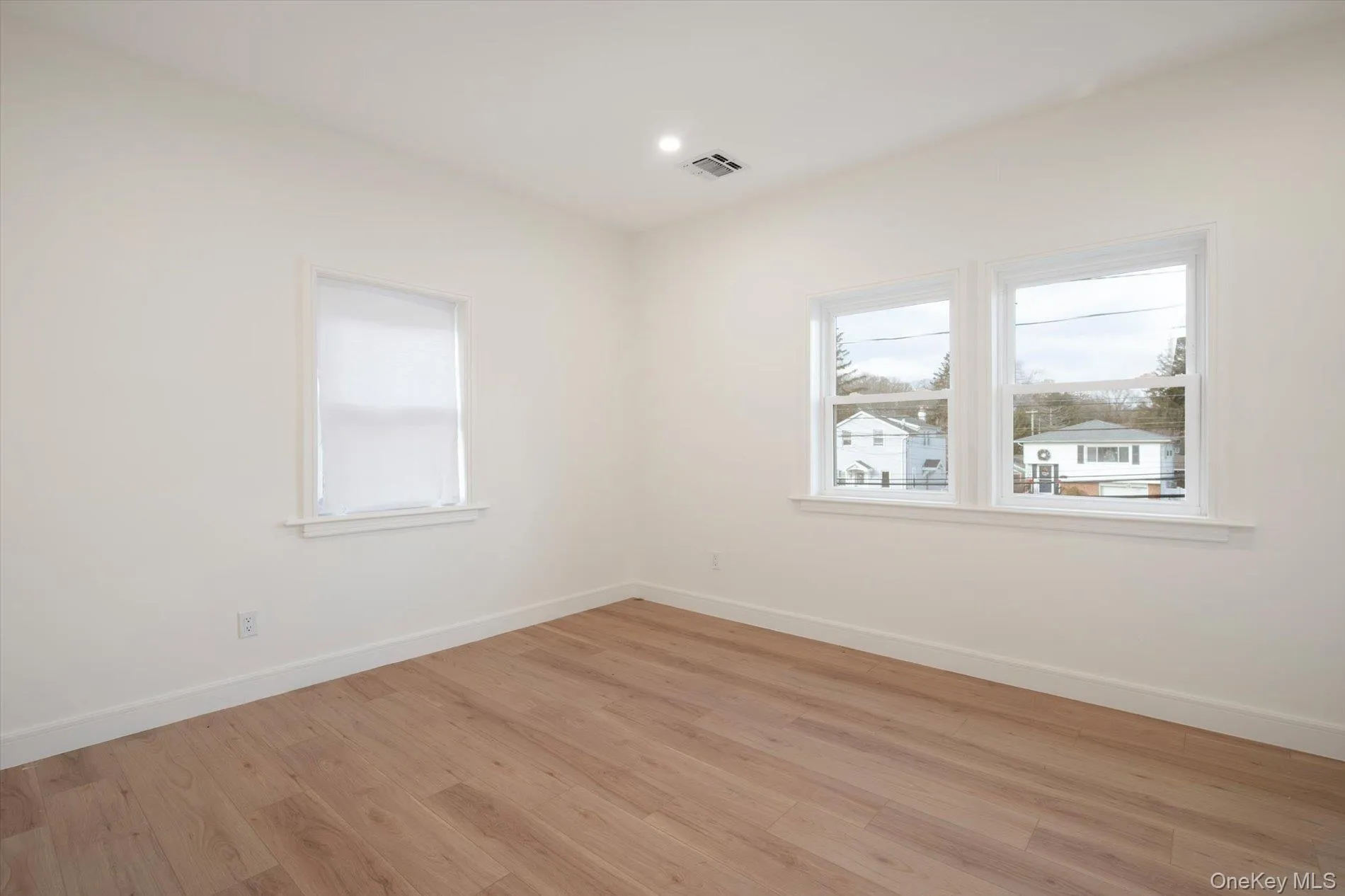 Unfurnished room with light wood-type flooring and recessed lighting Unfurnished room with light wood-type flooring and recessed lighting