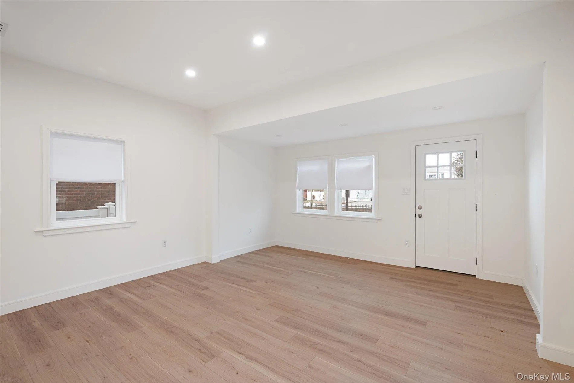 Entrance foyer with light wood-style floors and recessed lighting Entrance foyer with light wood-style floors and recessed lighting