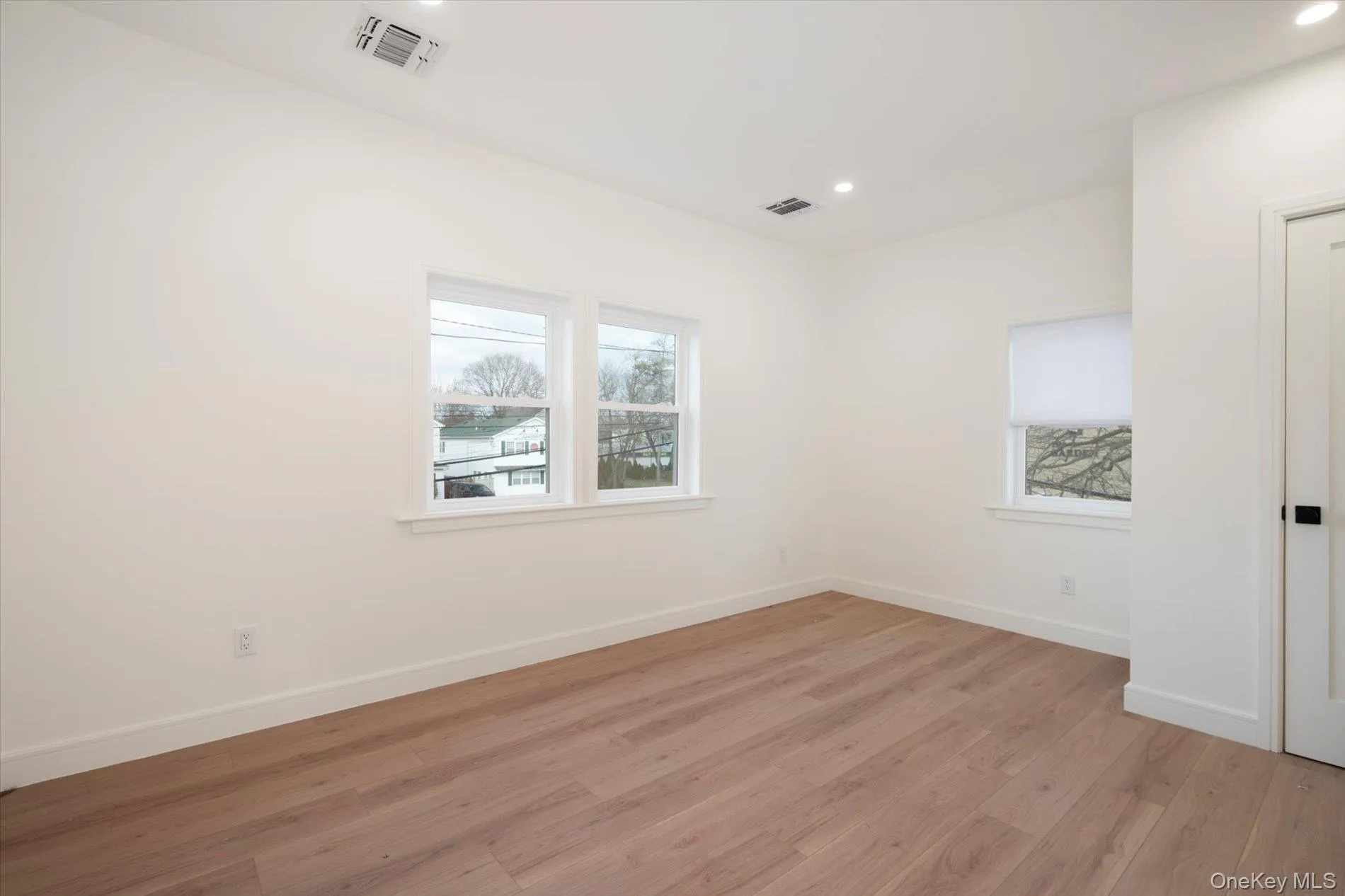 Empty room with light wood-style flooring and recessed lighting Empty room with light wood-style flooring and recessed lighting