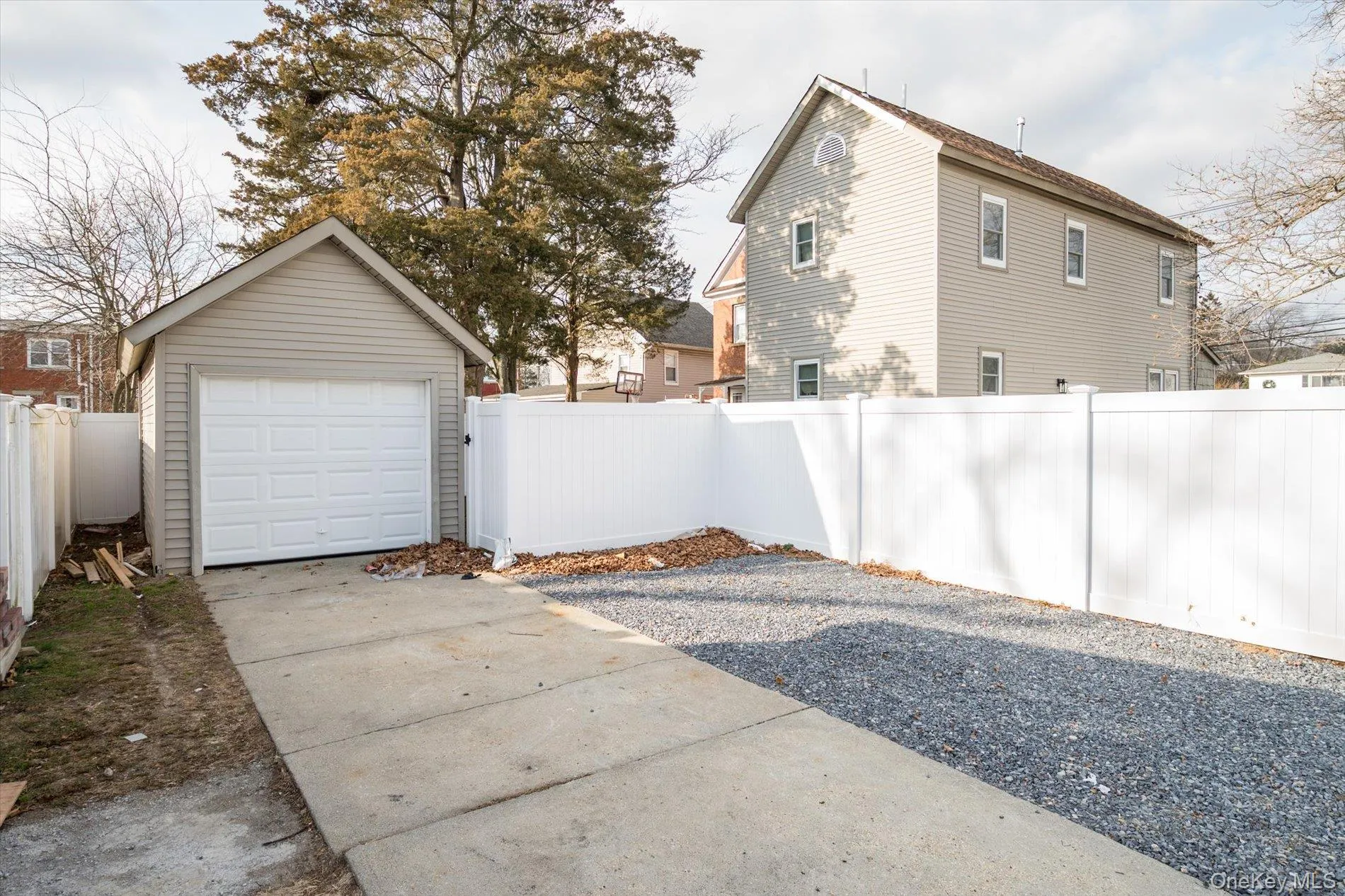 Detached garage featuring concrete driveway Detached garage featuring concrete driveway