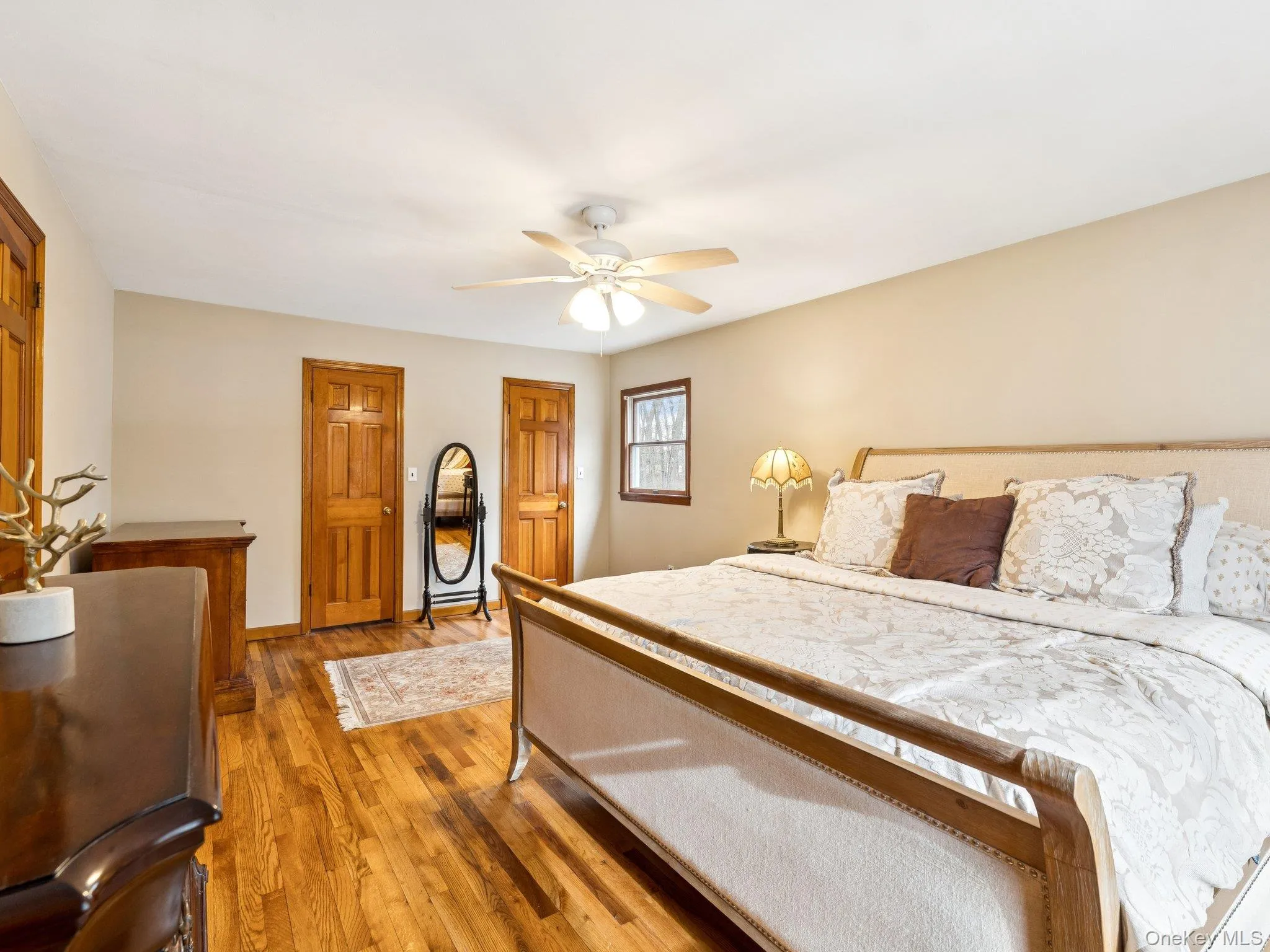 Bedroom with hardwood / wood-style flooring, ceiling fan, and two closets Bedroom with hardwood / wood-style flooring, ceiling fan, and two closets