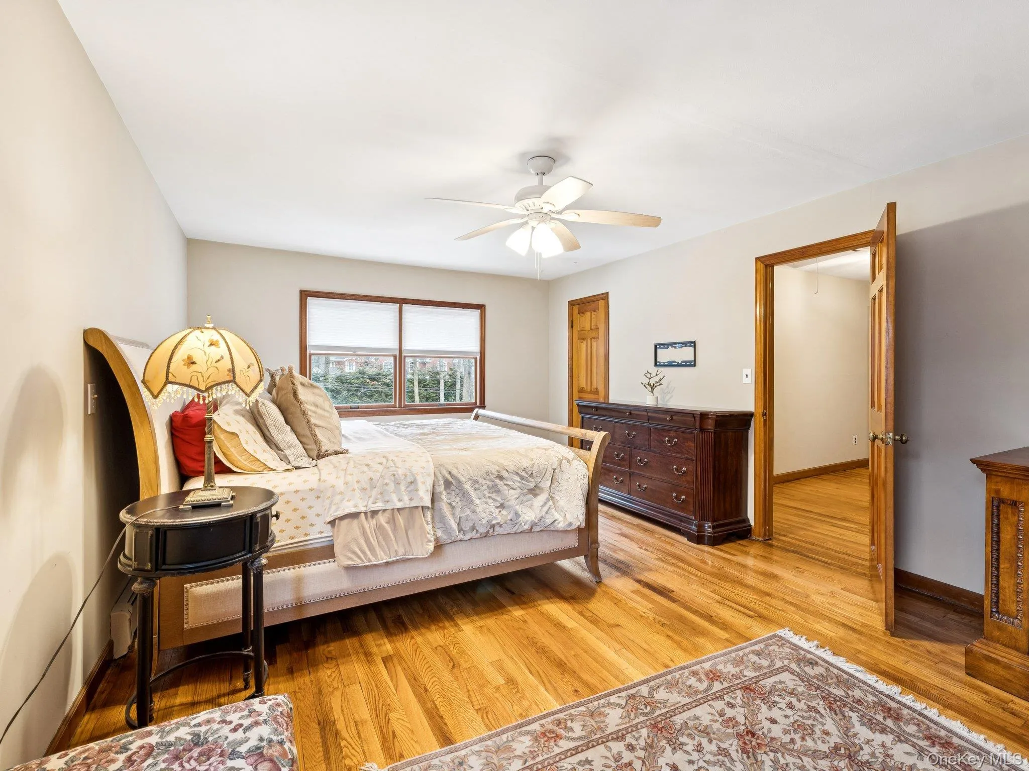 Bedroom featuring ceiling fan and light wood-type flooring Bedroom featuring ceiling fan and light wood-type flooring