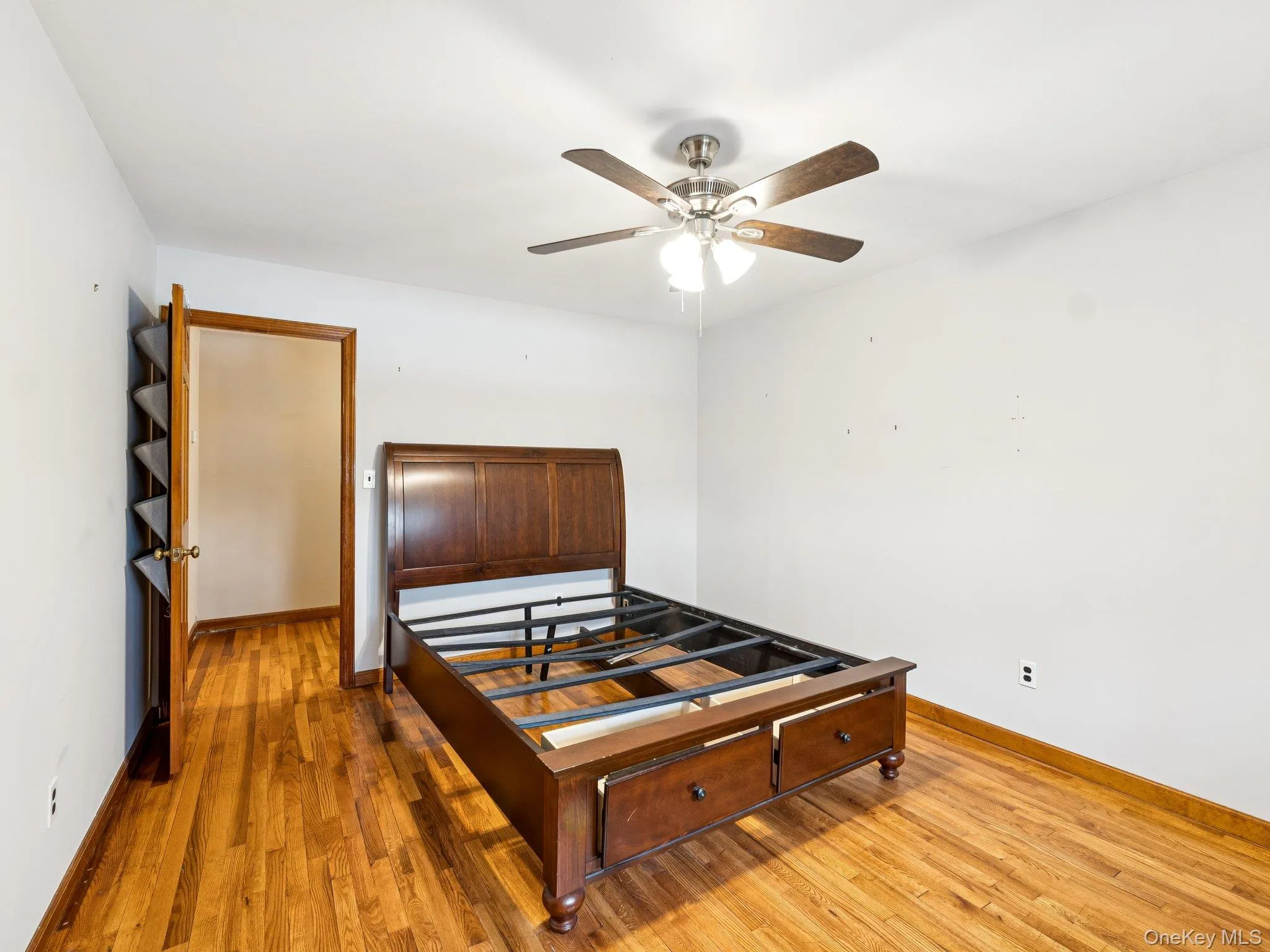 Bedroom featuring light wood finished floors and ceiling fan Bedroom featuring light wood finished floors and ceiling fan