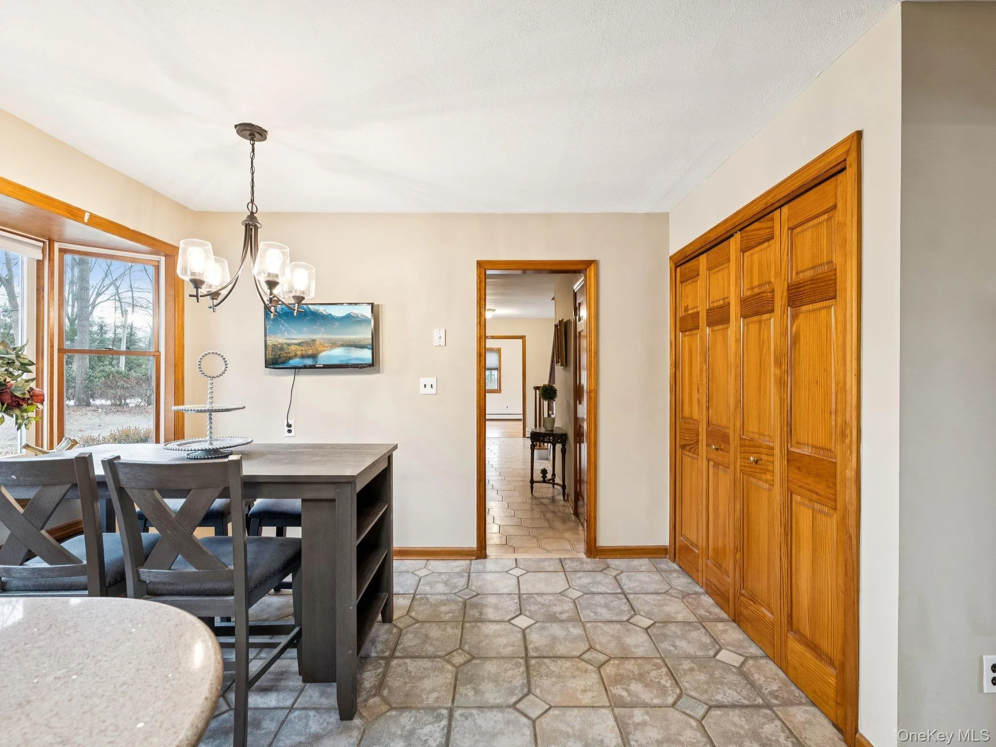 Dining area featuring a chandelier and baseboards Dining area featuring a chandelier and baseboards
