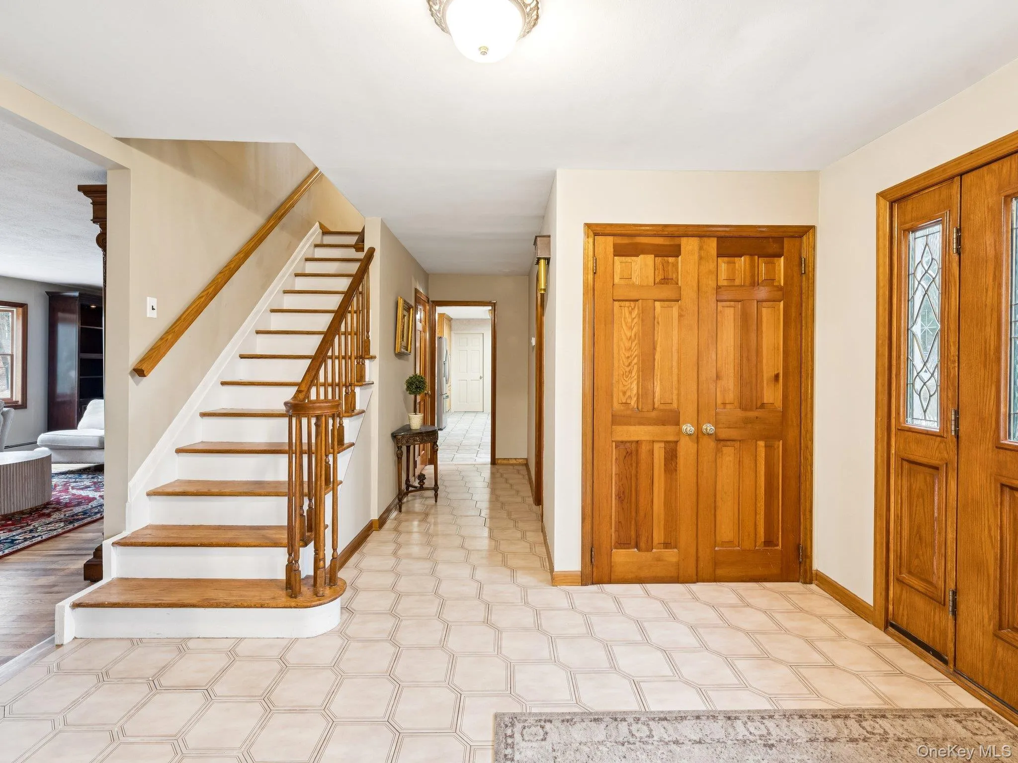 Foyer with stairs and light flooring Foyer with stairs and light flooring