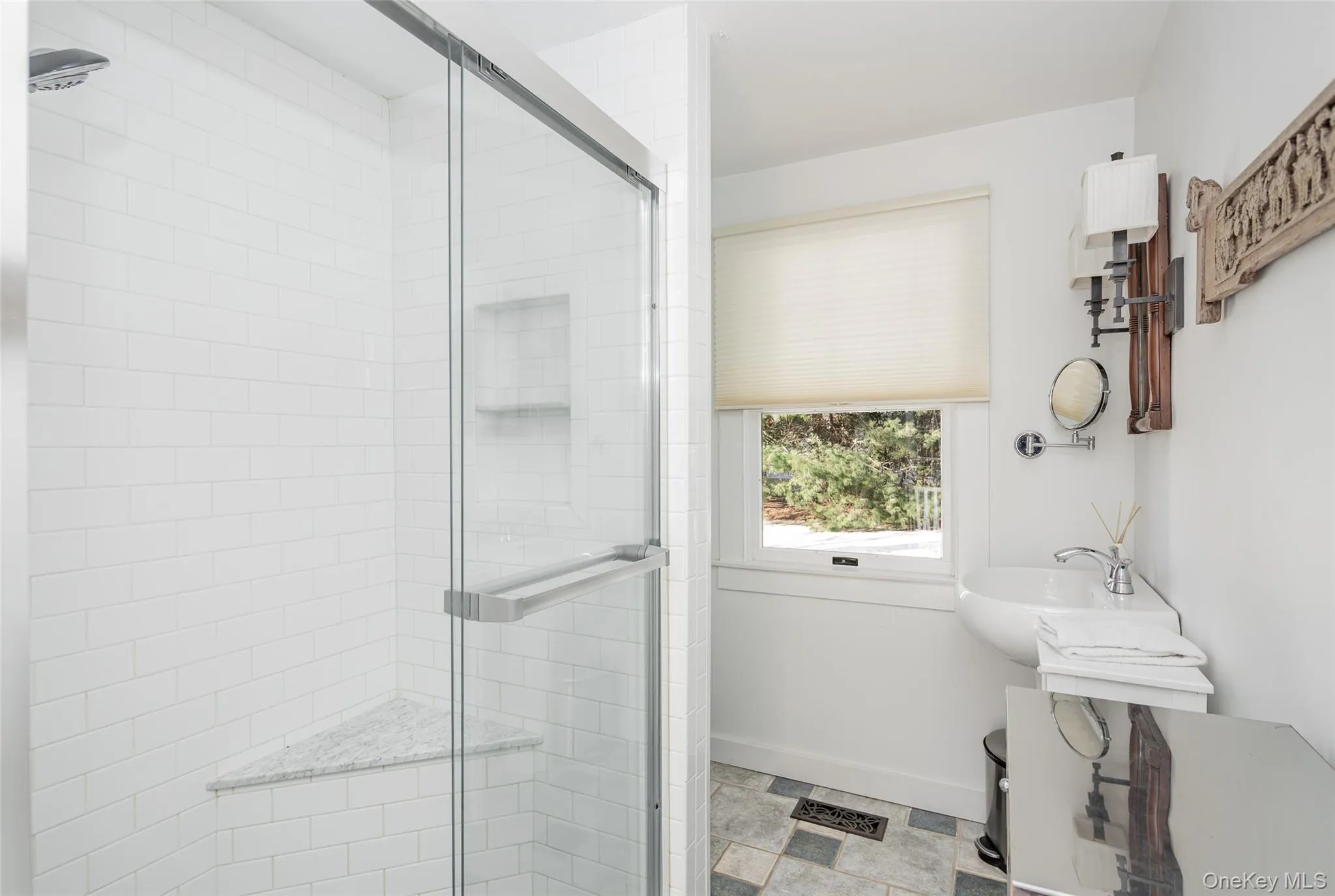 Full bath featuring a shower stall and a sink Full bath featuring a shower stall and a sink