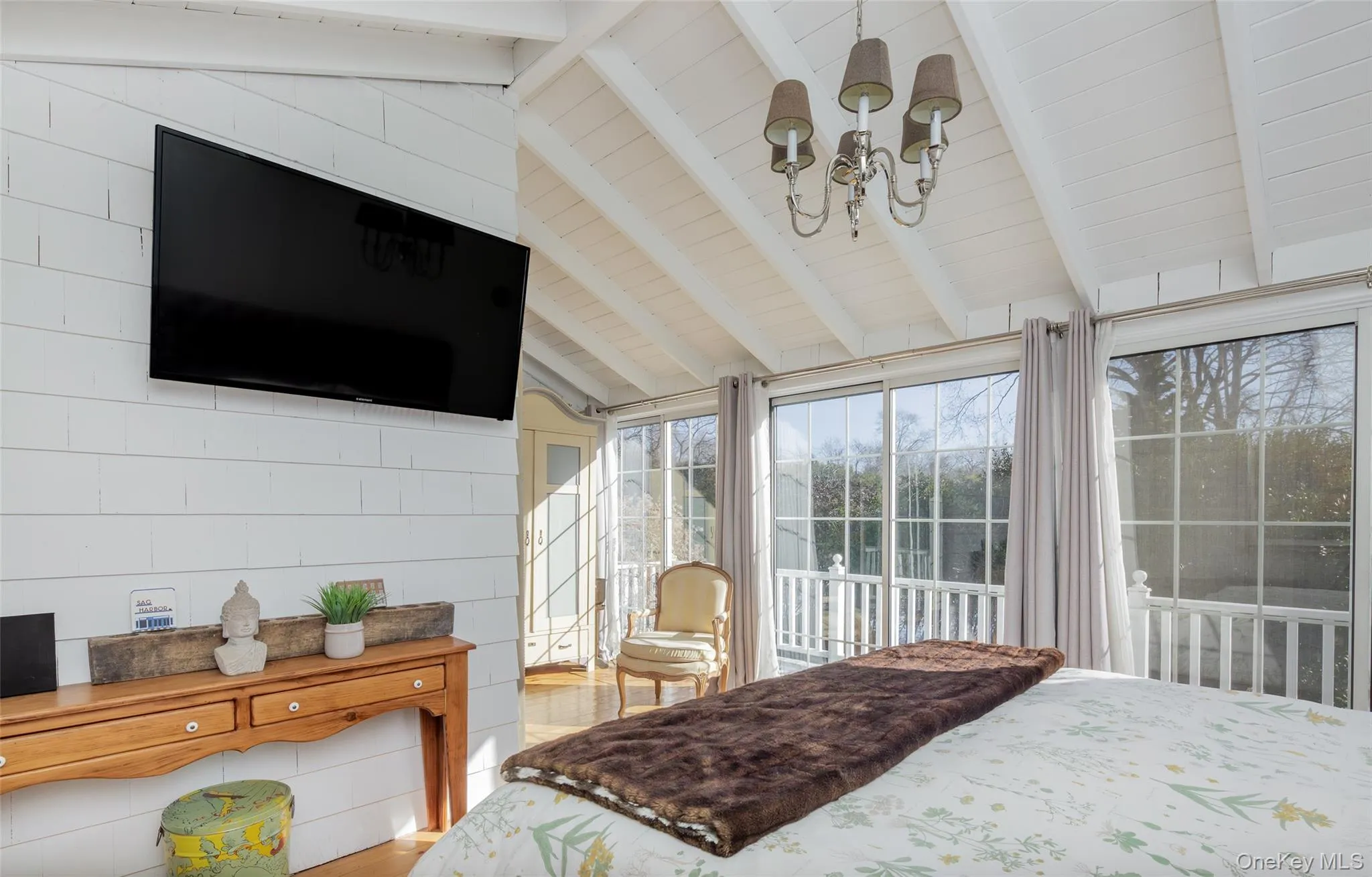 Bedroom with a chandelier, access to exterior, and wood finished floors Bedroom with a chandelier, access to exterior, and wood finished floors