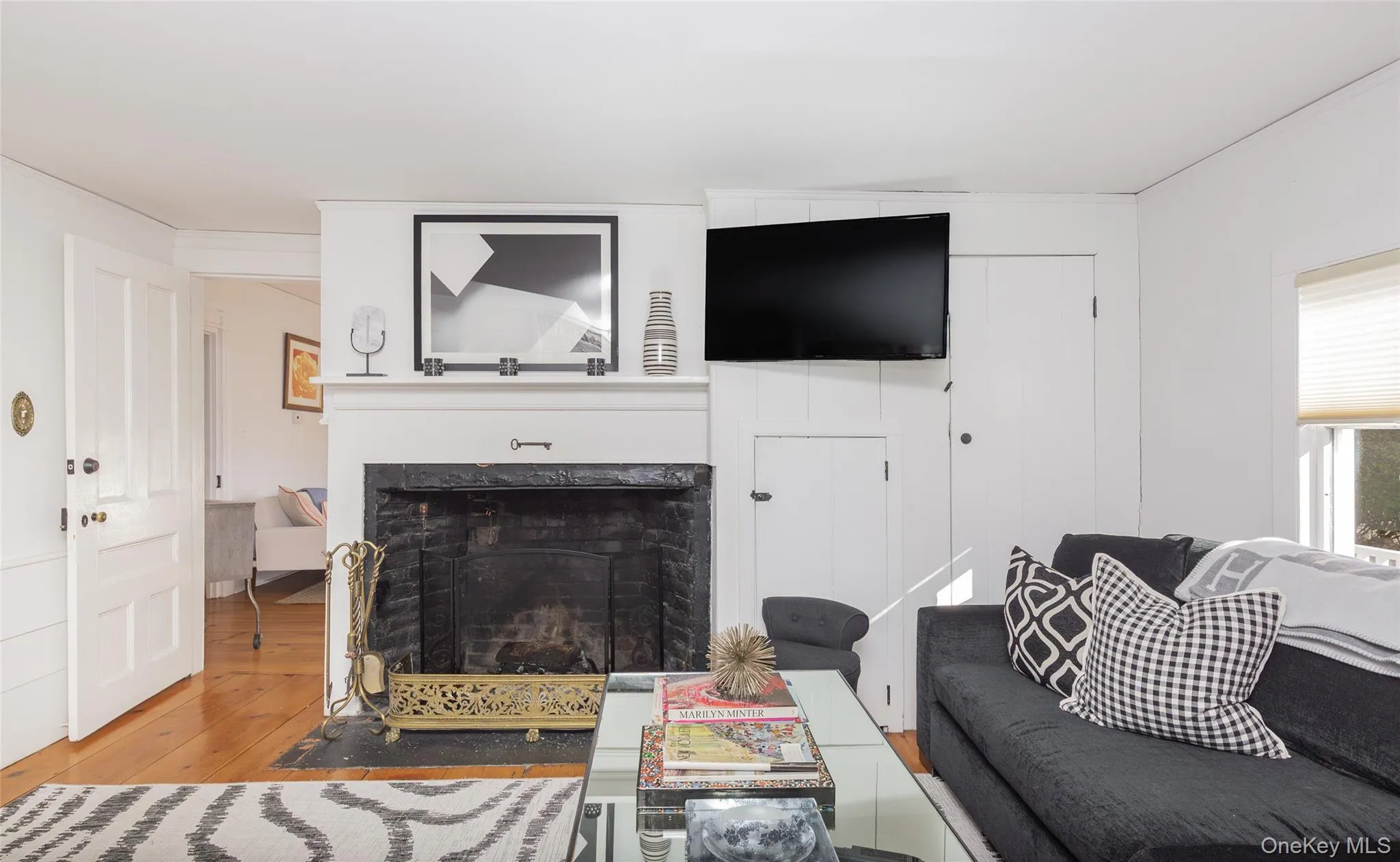 Living room featuring a premium fireplace and hardwood / wood-style flooring Living room featuring a premium fireplace and hardwood / wood-style flooring