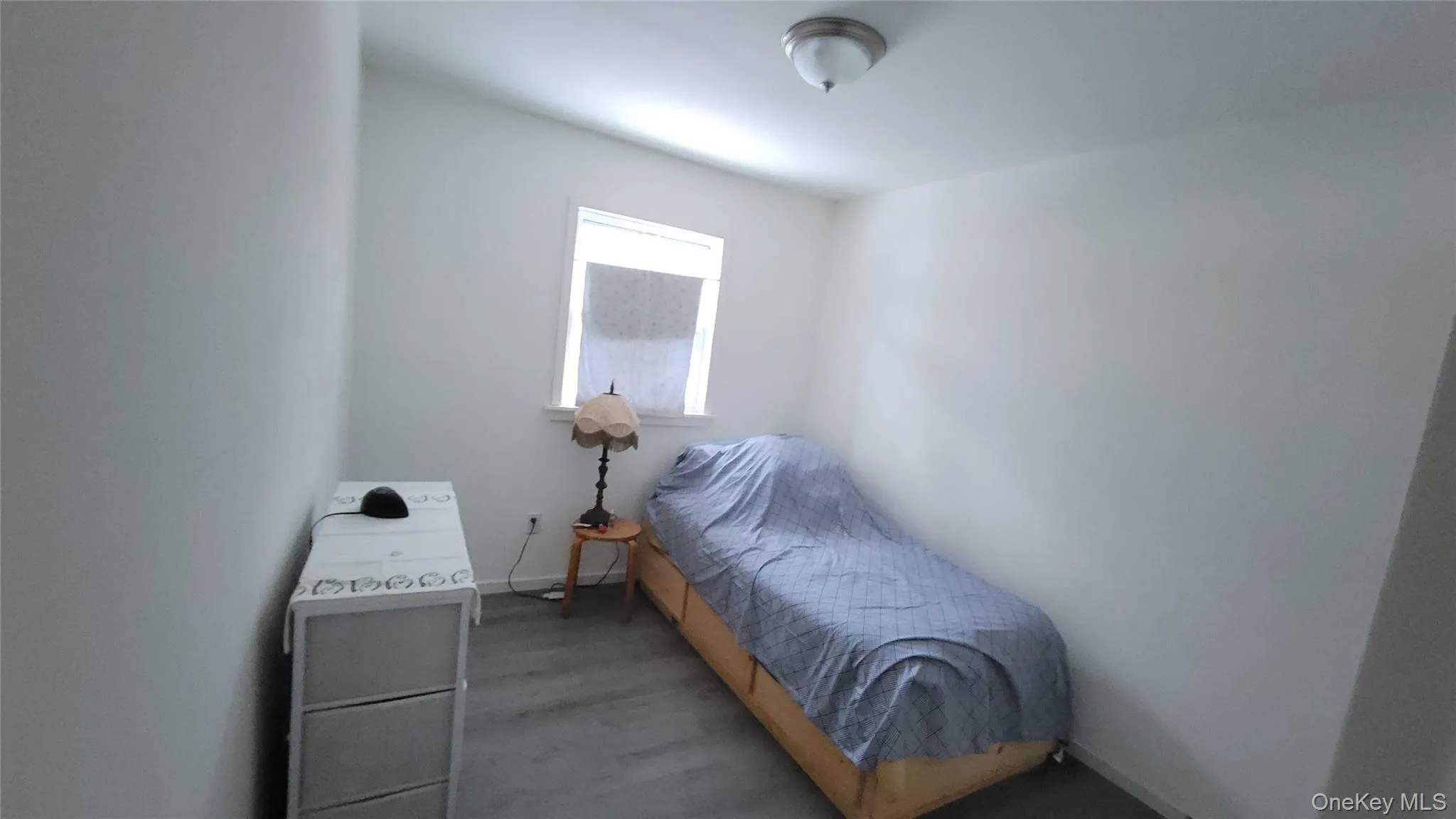 Bedroom with wood finished floors and baseboards Bedroom with wood finished floors and baseboards