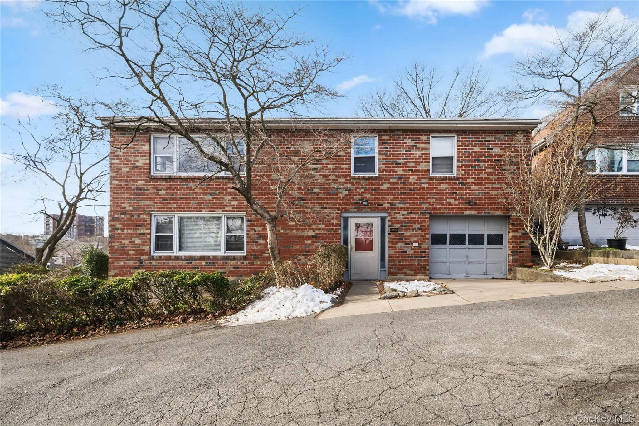 View of front of house with brick siding, an attached garage, and driveway View of front of house with brick siding, an attached garage, and driveway