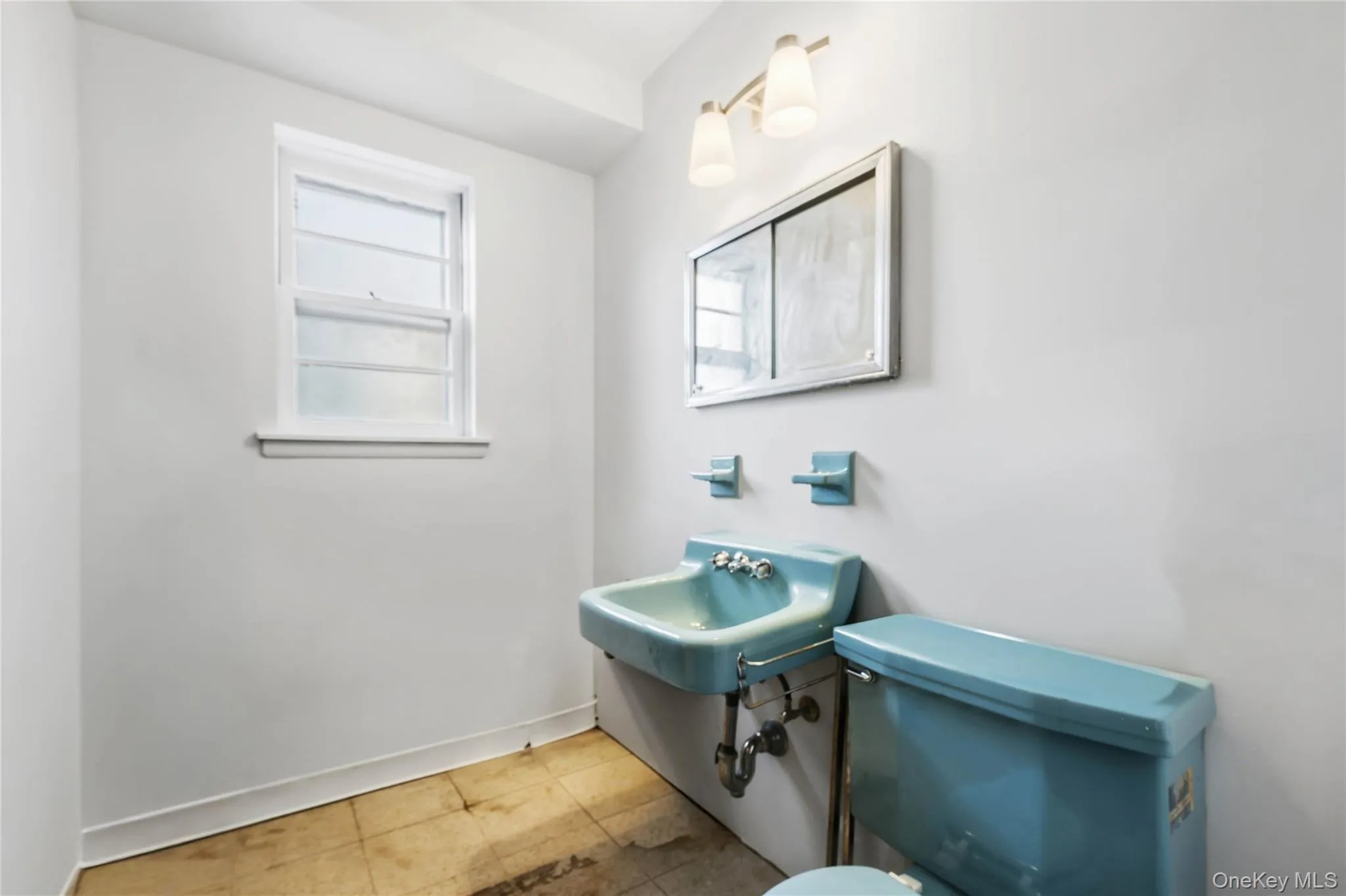 Half bathroom featuring toilet and baseboards Half bathroom featuring toilet and baseboards