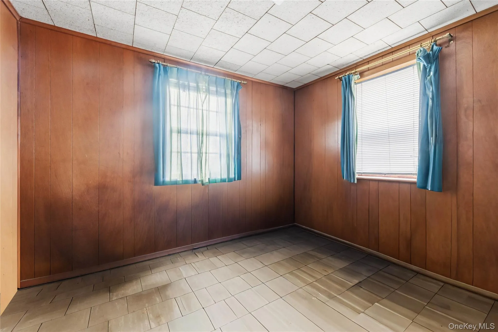 Empty room featuring wood walls Empty room featuring wood walls