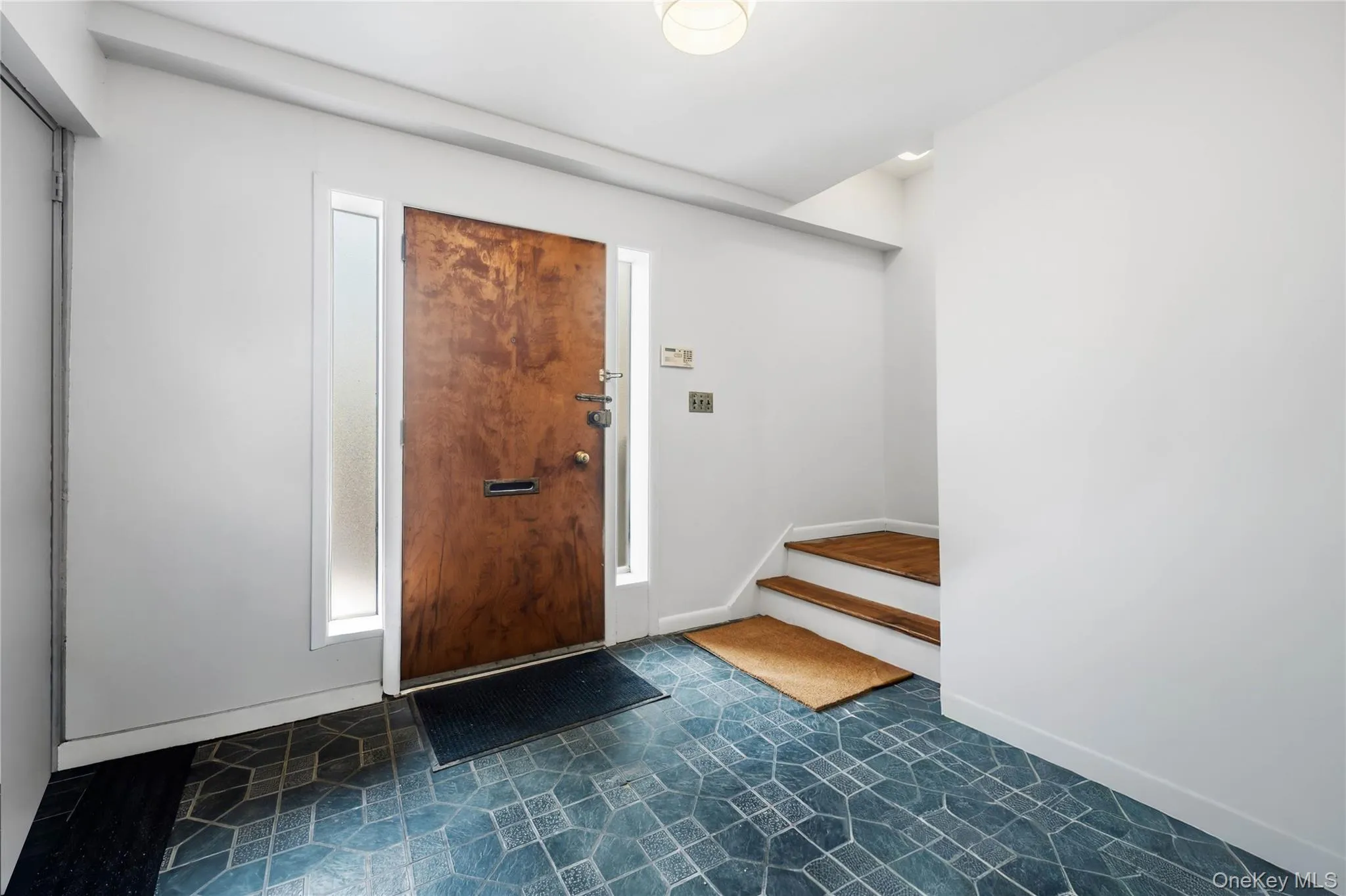 Foyer entrance featuring baseboards and stairway Foyer entrance featuring baseboards and stairway