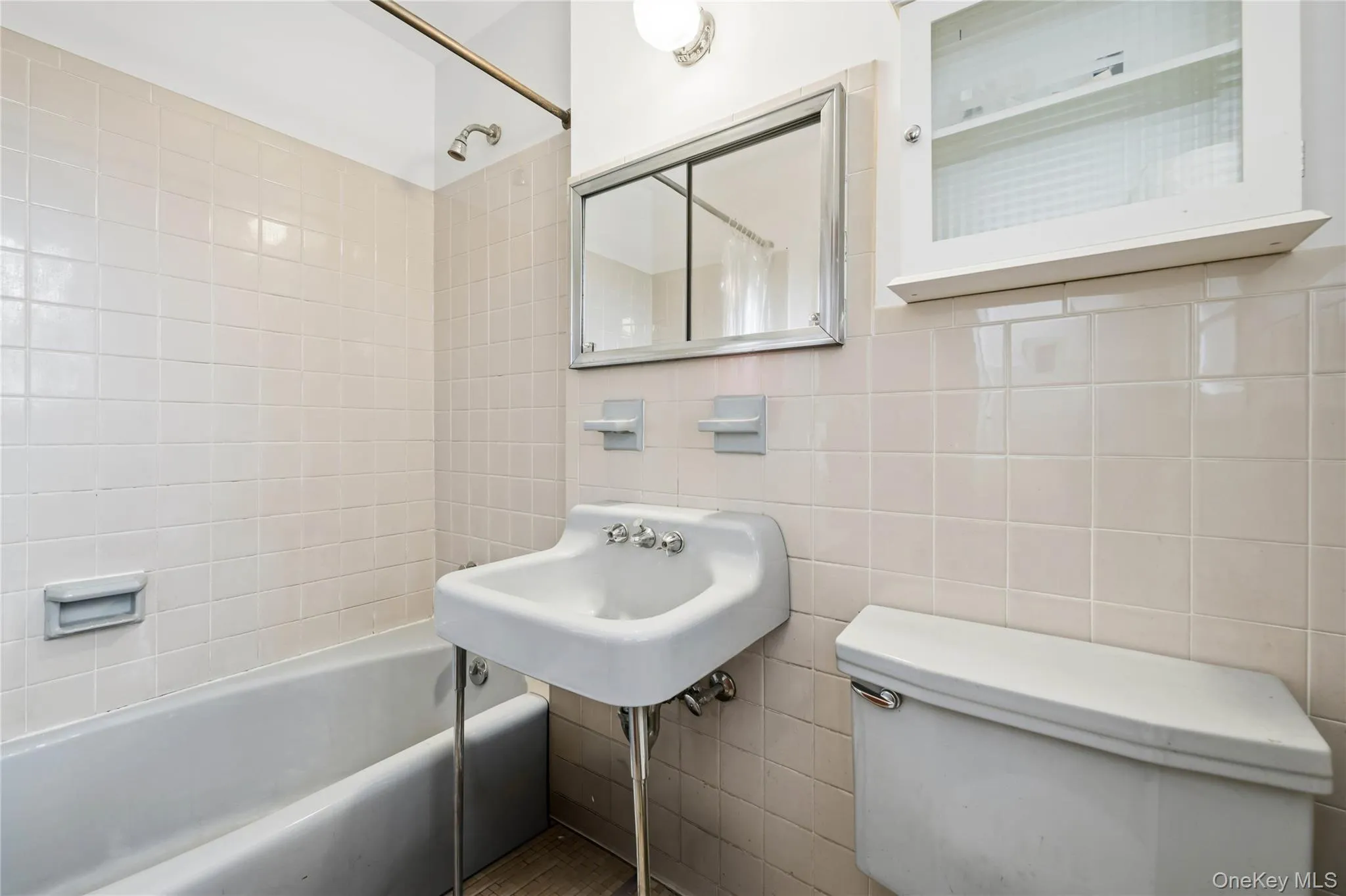 Full bath with shower combination and tile walls Full bath with shower combination and tile walls