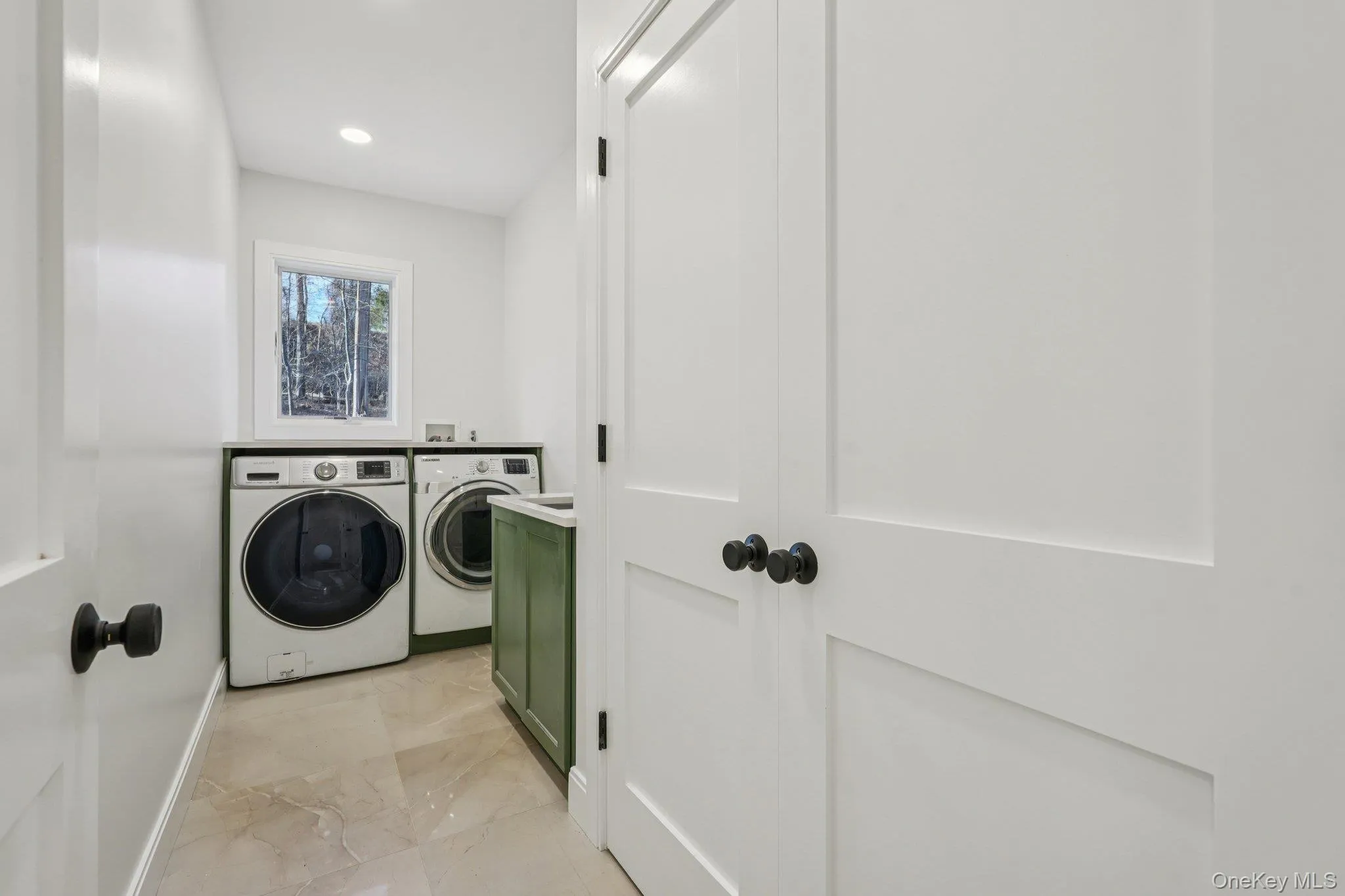 Large laundry room on the second level with sink and large linen closet. Large laundry room on the second level with sink and large linen closet.