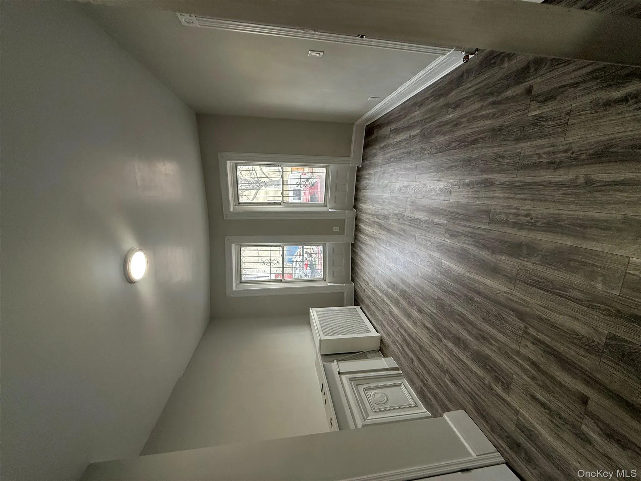 Unfurnished room featuring dark wood finished floors and radiator Unfurnished room featuring dark wood finished floors and radiator