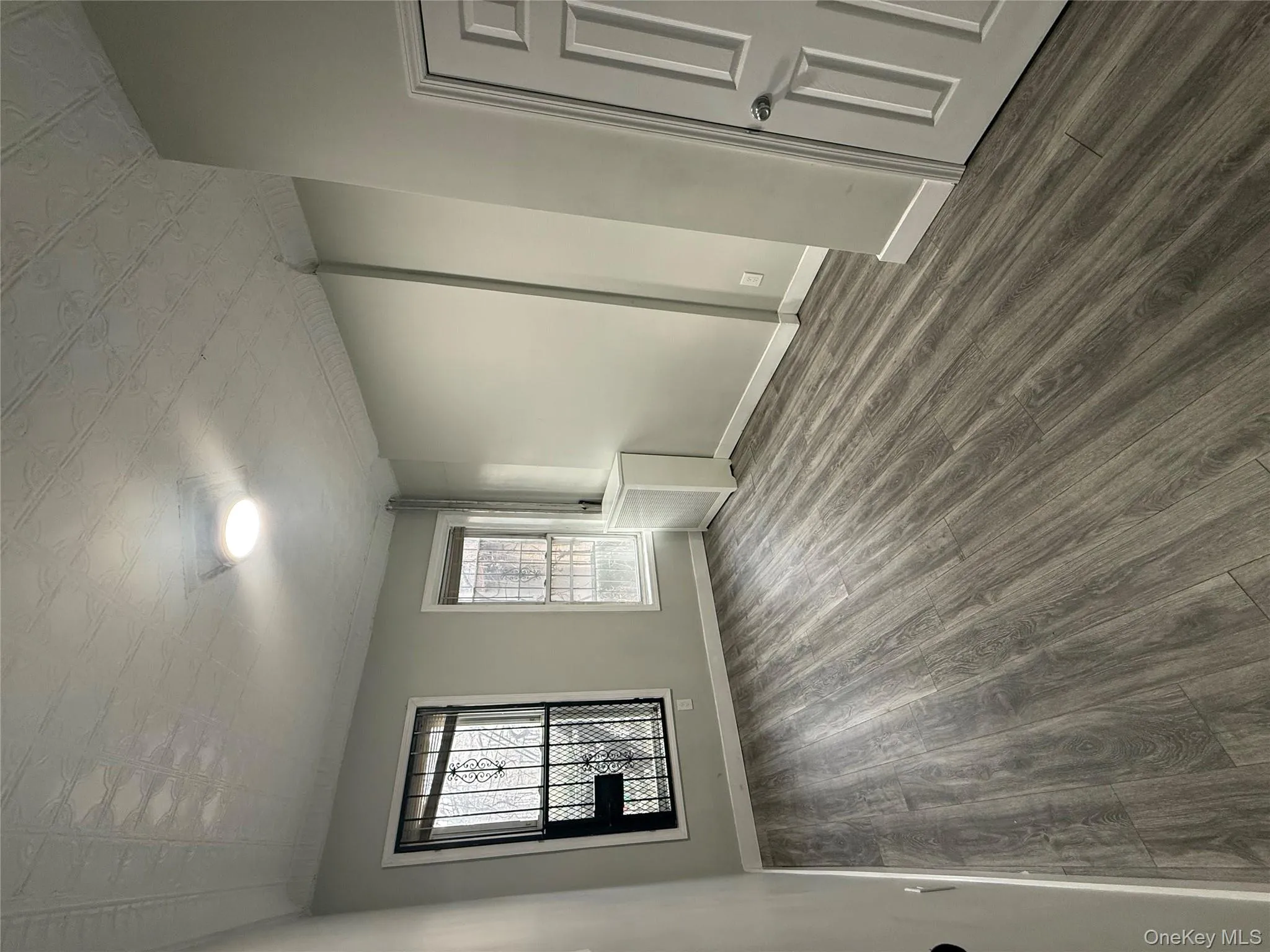 Empty room with dark wood-type flooring and an ornate ceiling Empty room with dark wood-type flooring and an ornate ceiling