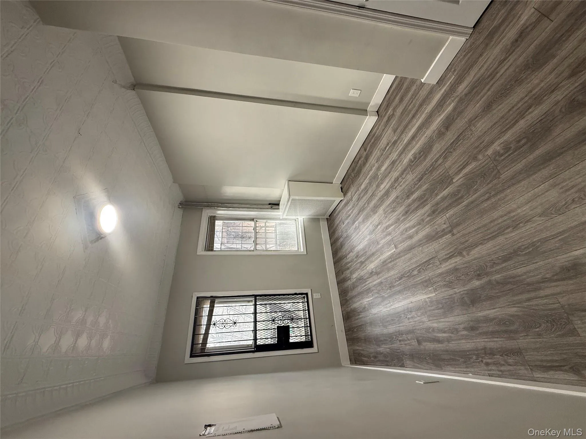 Spare room with dark wood-type flooring and an ornate ceiling Spare room with dark wood-type flooring and an ornate ceiling