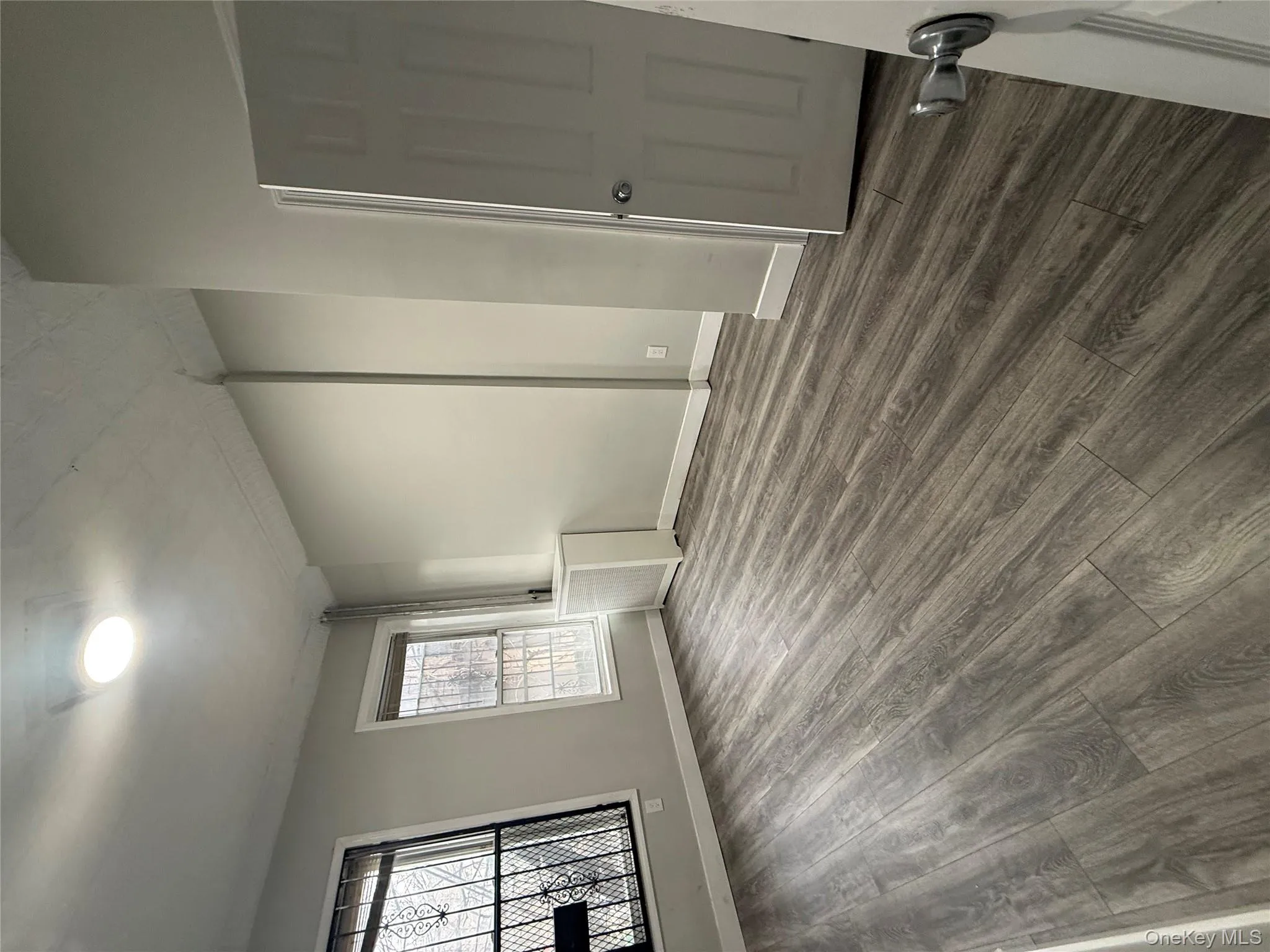 Unfurnished room featuring dark wood-style floors and baseboards Unfurnished room featuring dark wood-style floors and baseboards