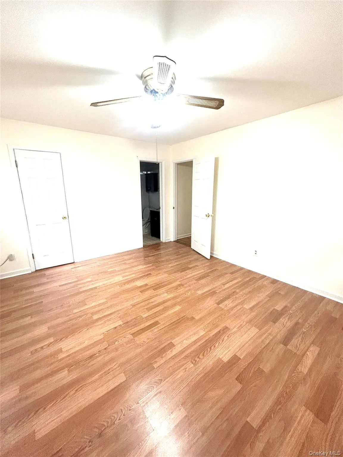 Unfurnished bedroom with light wood finished floors, ceiling fan, and a closet Unfurnished bedroom with light wood finished floors, ceiling fan, and a closet