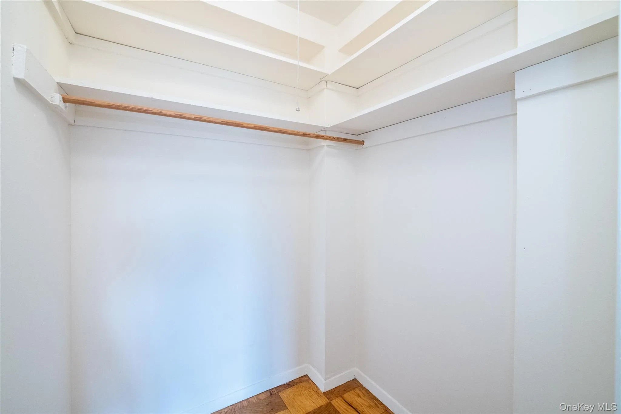 Walk in closet featuring parquet floors Walk in closet featuring parquet floors