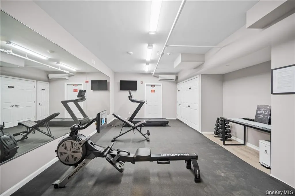 Exercise room featuring a wall mounted air conditioner Exercise room featuring a wall mounted air conditioner