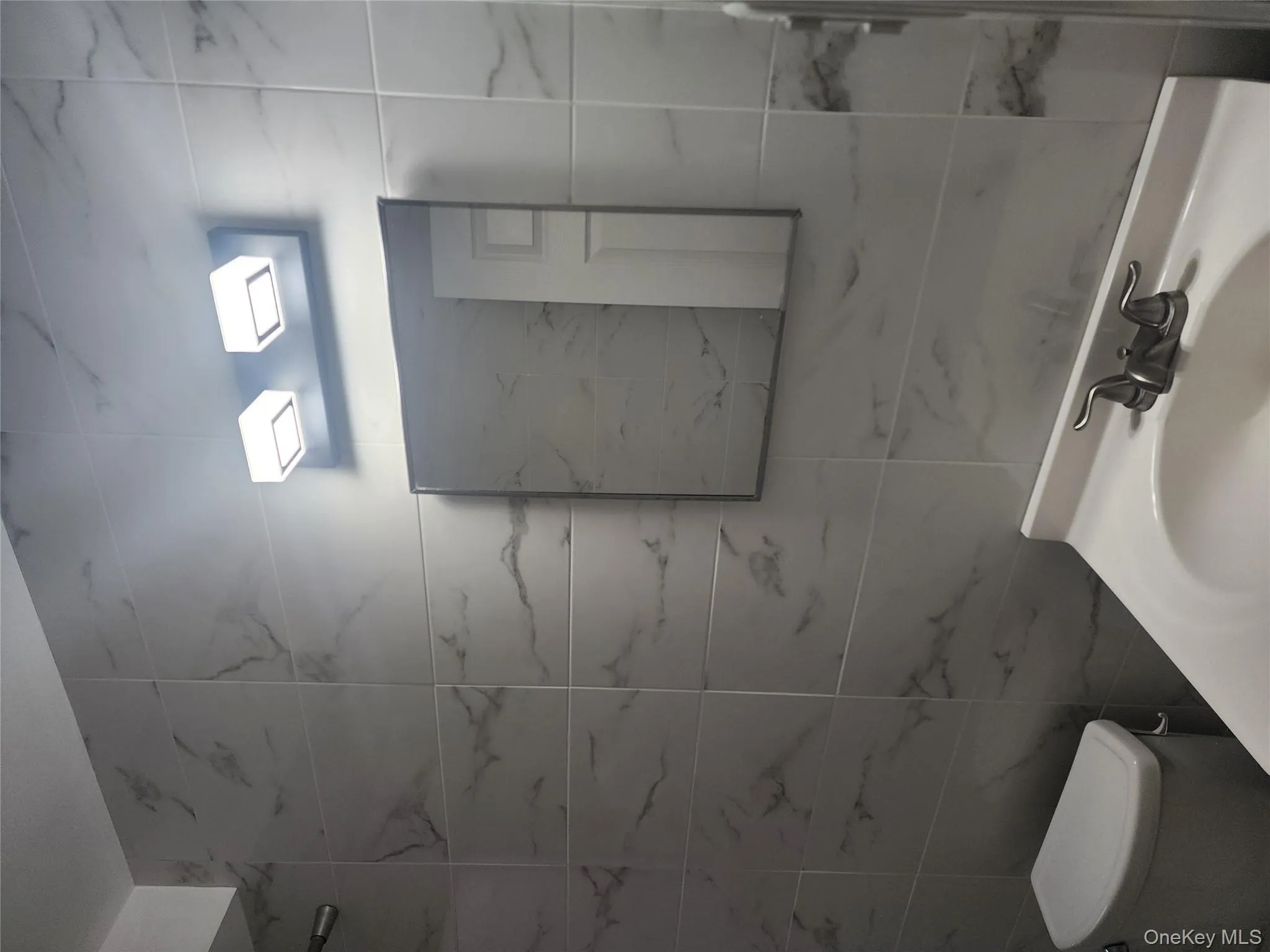 Bathroom featuring tile walls and vanity Bathroom featuring tile walls and vanity