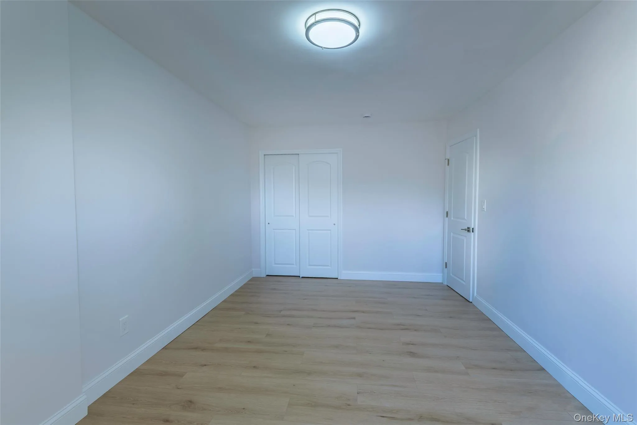 Unfurnished bedroom featuring light wood-style flooring and a closet Unfurnished bedroom featuring light wood-style flooring and a closet