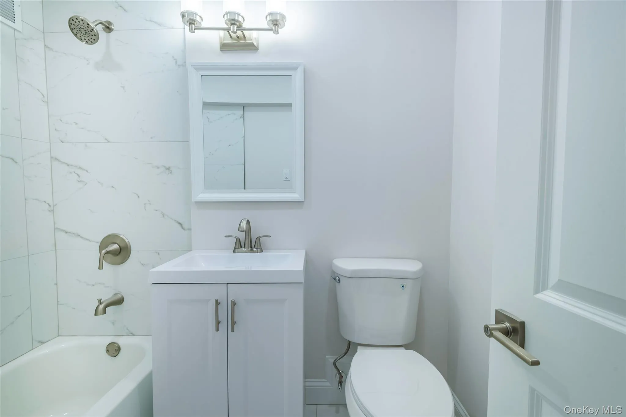 Full bathroom with vanity and shower / bath combination Full bathroom with vanity and shower / bath combination