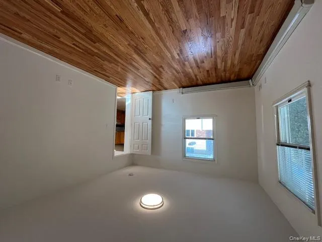 Unfurnished bedroom with baseboard heating and light wood finished floors Unfurnished bedroom with baseboard heating and light wood finished floors