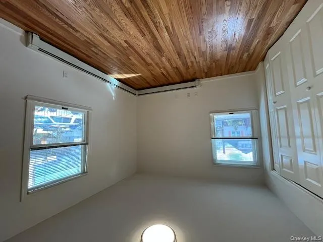 Unfurnished bedroom with a baseboard heating unit, light wood-style flooring, and a closet Unfurnished bedroom with a baseboard heating unit, light wood-style flooring, and a closet