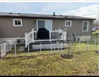 Back of house featuring a deck and a fenced backyard Back of house featuring a deck and a fenced backyard