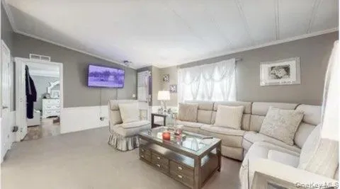 Living room with lofted ceiling and carpet floors Living room with lofted ceiling and carpet floors