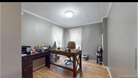 Home office with light wood-style floors Home office with light wood-style floors