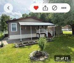 View of front of property featuring covered porch and a front yard View of front of property featuring covered porch and a front yard