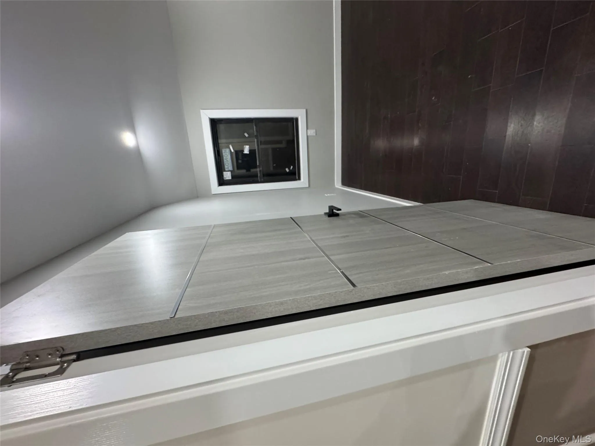 Corridor with dark wood-type flooring and baseboards Corridor with dark wood-type flooring and baseboards