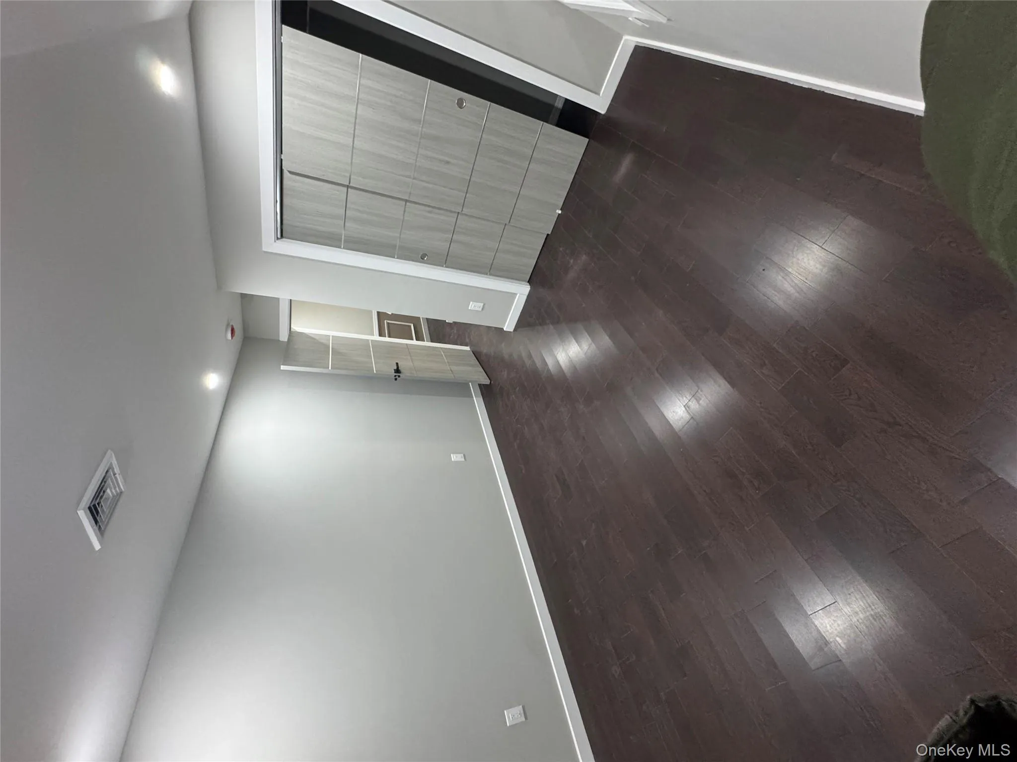 Unfurnished bedroom with dark wood-style flooring, a closet, and recessed lighting Unfurnished bedroom with dark wood-style flooring, a closet, and recessed lighting